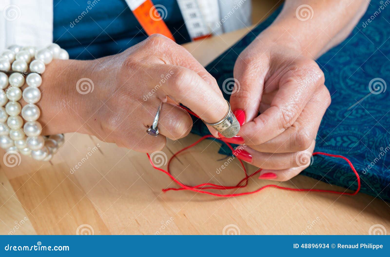 A Woman Threader the Wire in a Needle Stock Photo Image of tailor