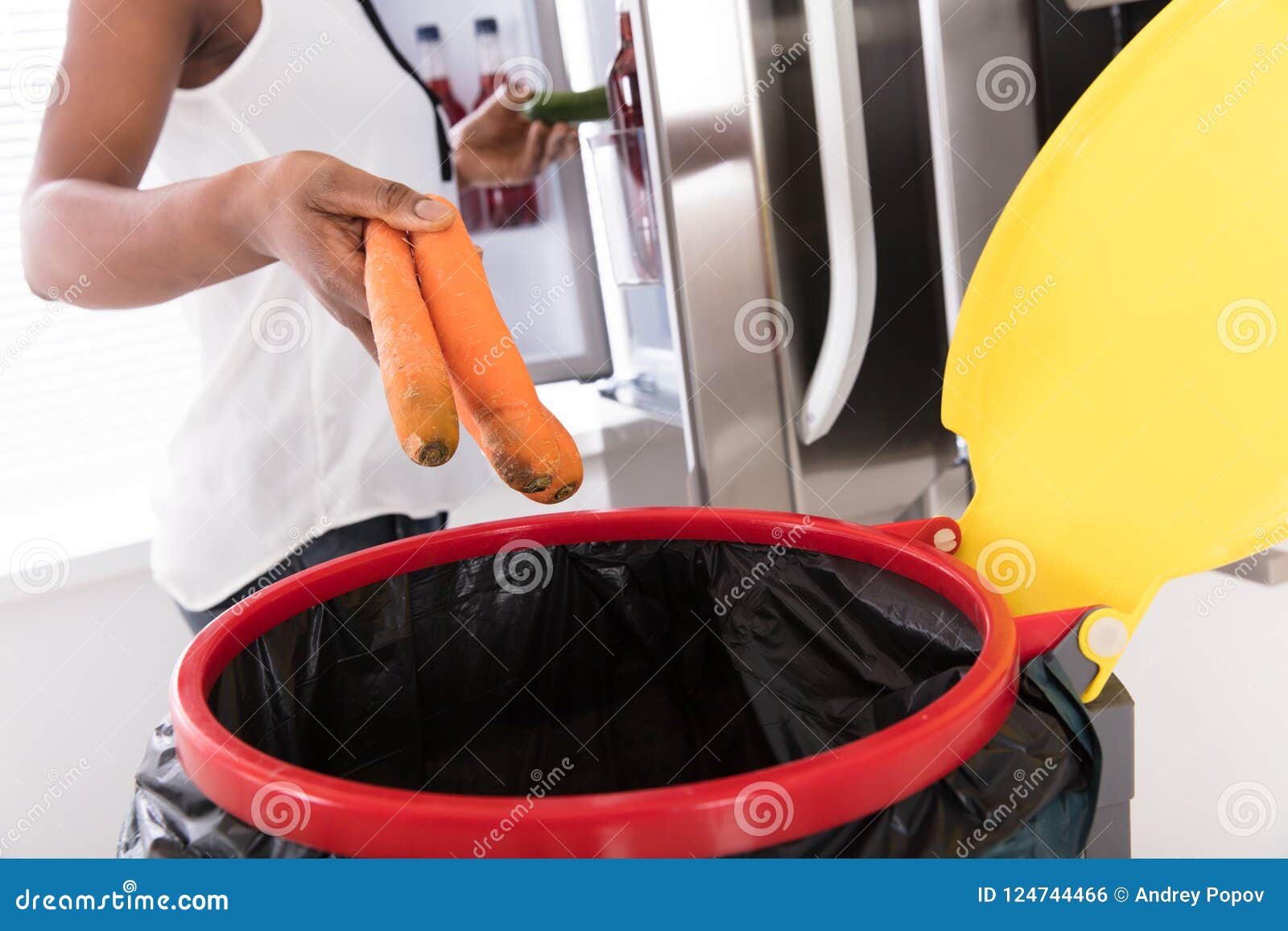 Woman Throwing Carrot in Trash Bin Stock Photo Image of afro, organic