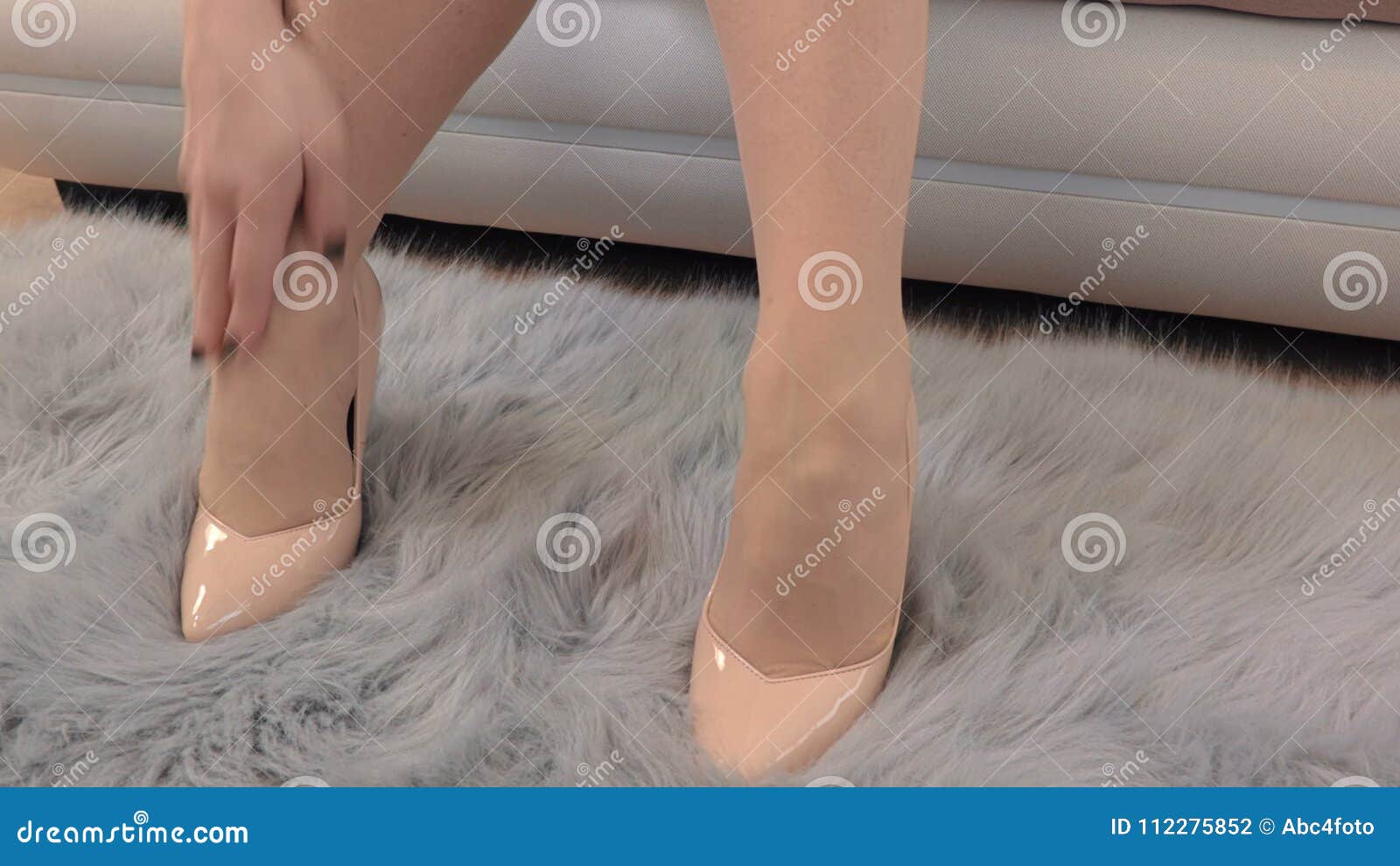 Female feet and heels, woman's lags get tied of shoes with high hill, woman  after party, closeup 17467206 Stock Photo at Vecteezy