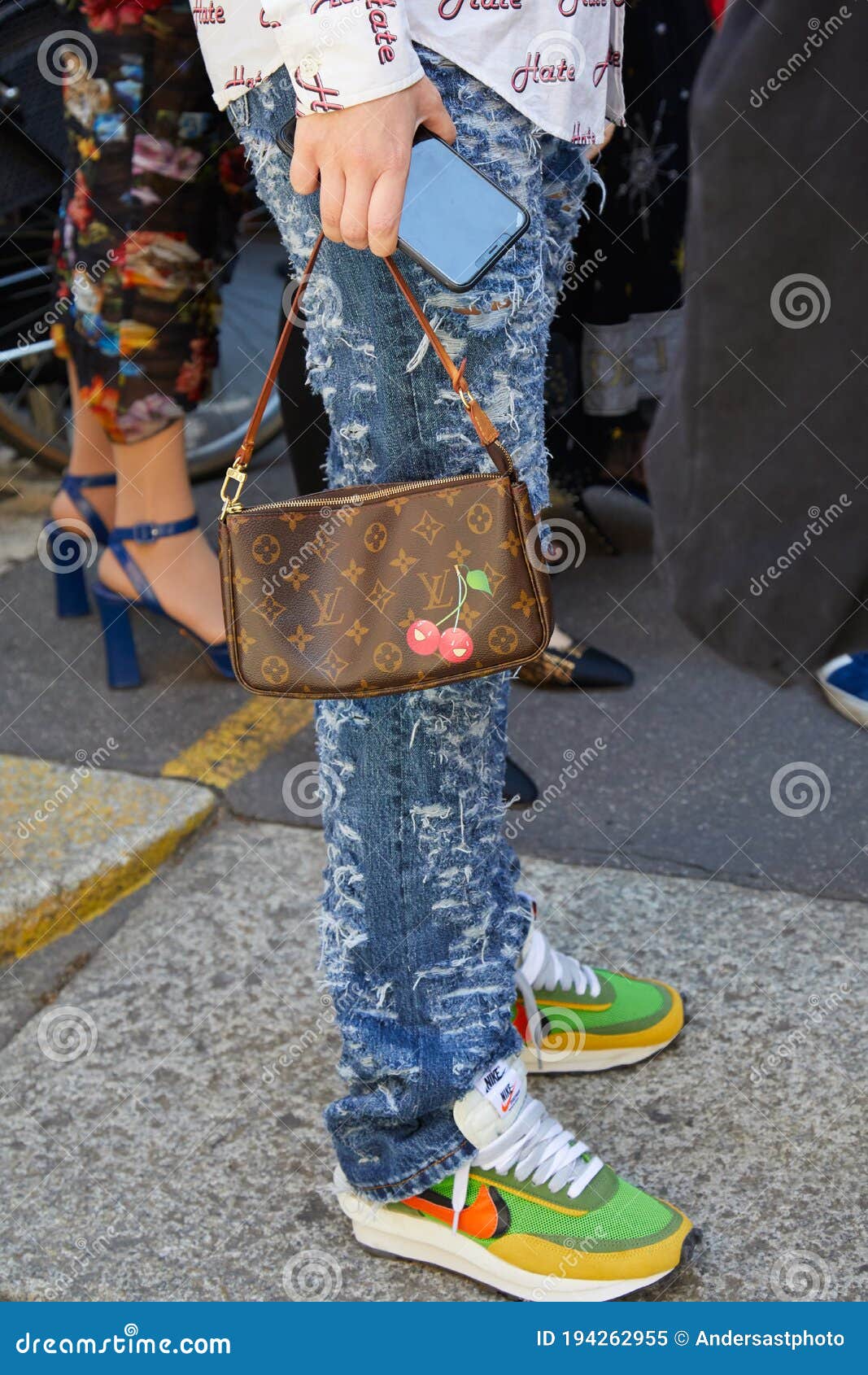 Woman with Torn Denim Trousers, Louis Vuitton Bag and Nike