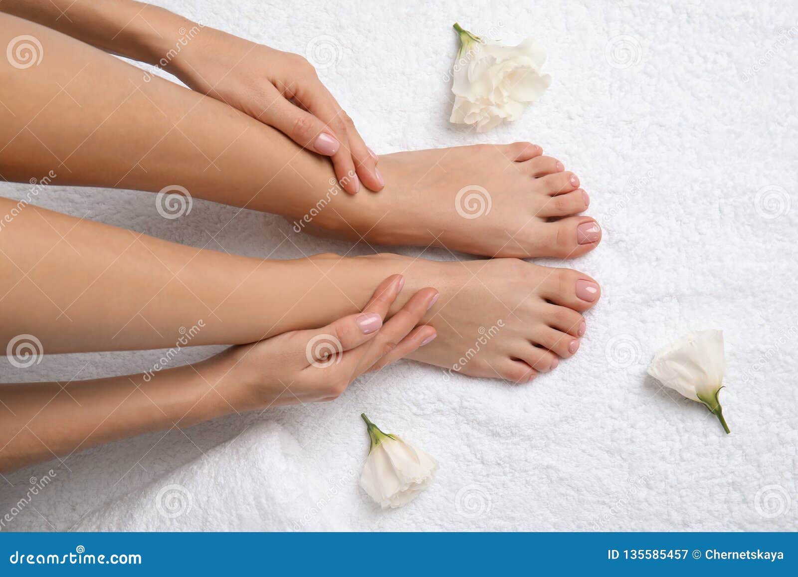 Woman Touching Her Smooth Feet On White Towel Top View Stock Image