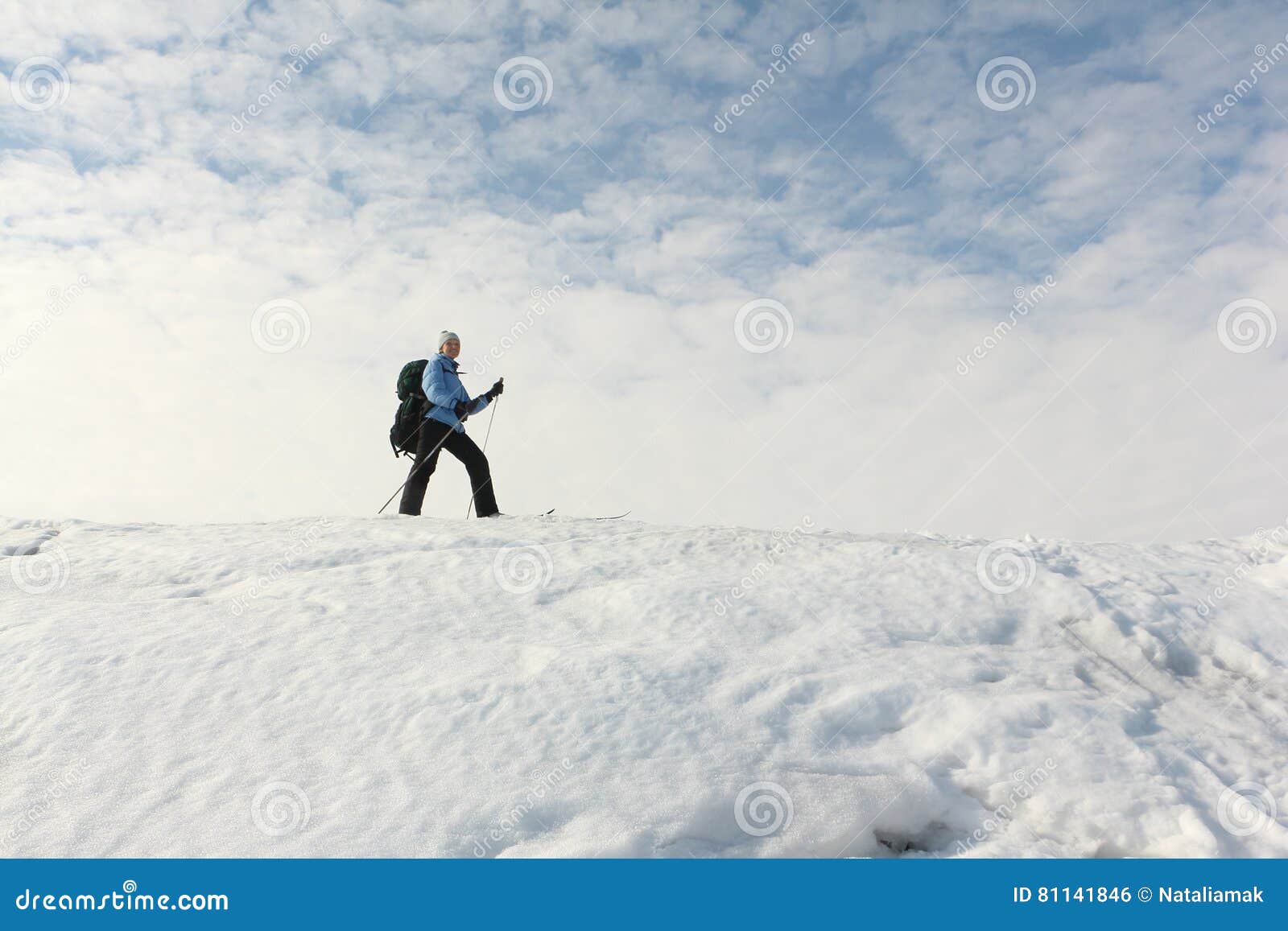 The Woman Traveler with Backpack Skiing on the Snow Stock Photo - Image ...