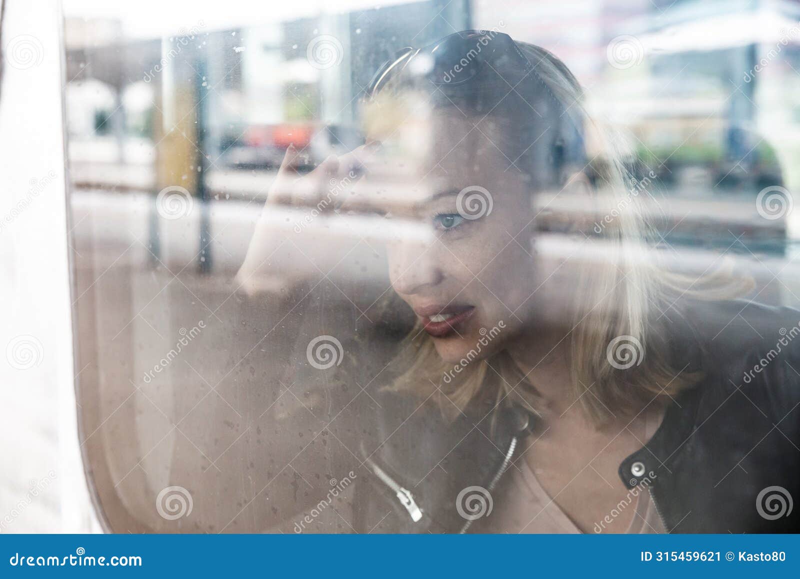 woman traveler contemplating outdoor view from window of train. young lady on commute travel to work sitting in bus or
