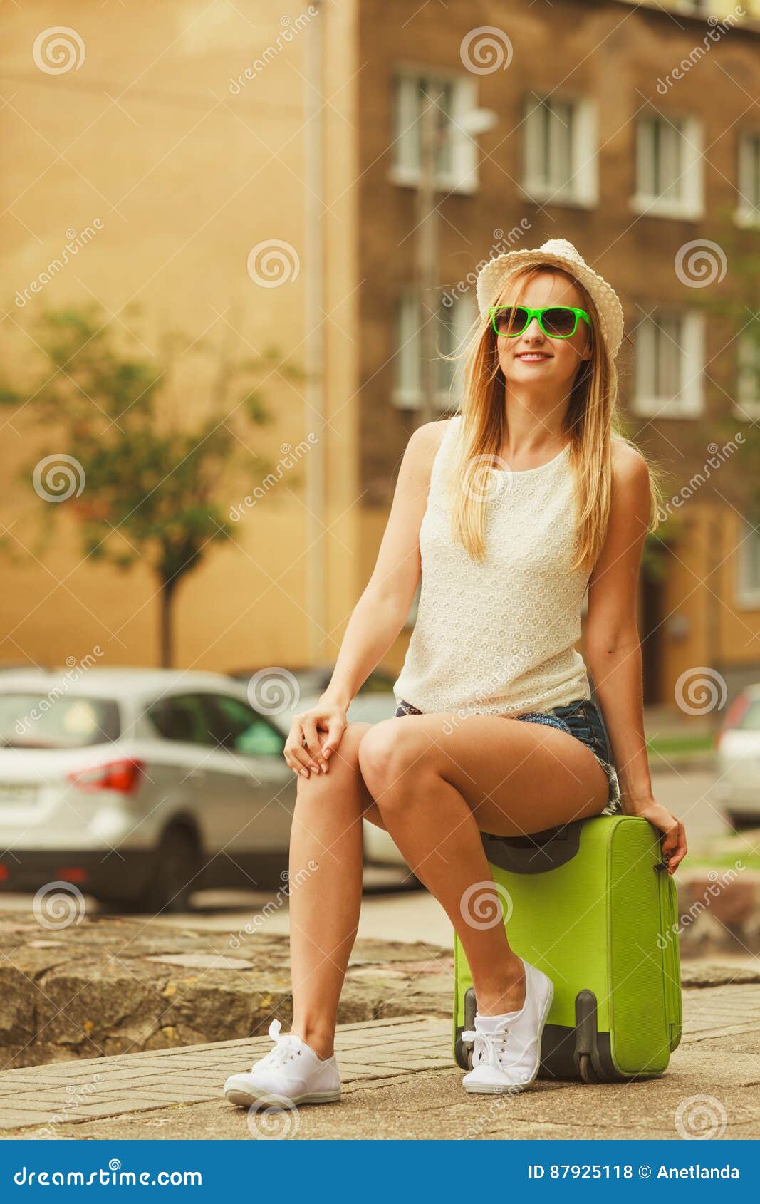 Woman Traveler Sits on Suitcase Waiting for Car. Stock Photo - Image of ...