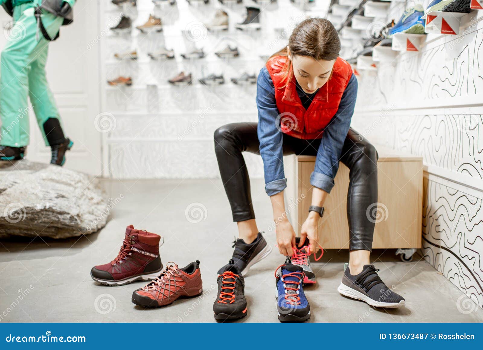 Woman Trying Shoes for Hiking in the Shop Stock - Image of