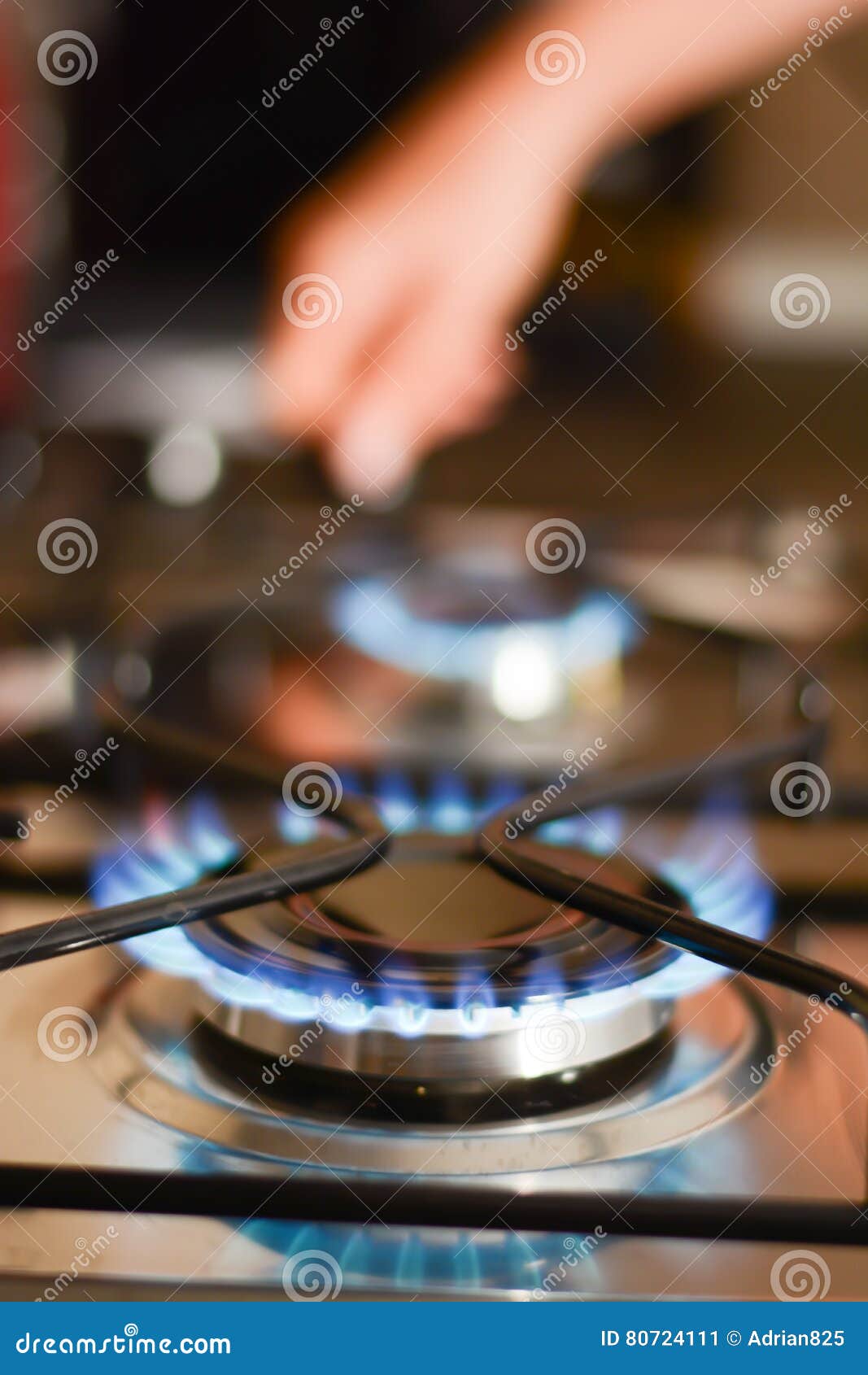 Woman turning on a stove stock image. Image of domestic 80724111