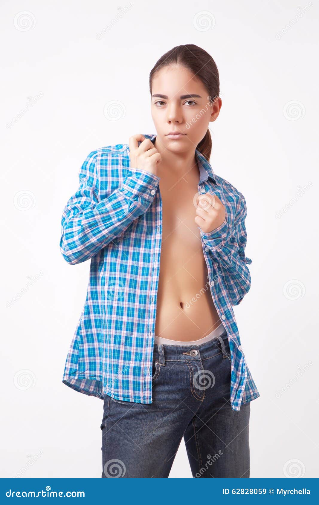 Photo about Woman in unbuttoned blue shirt and jeans. 