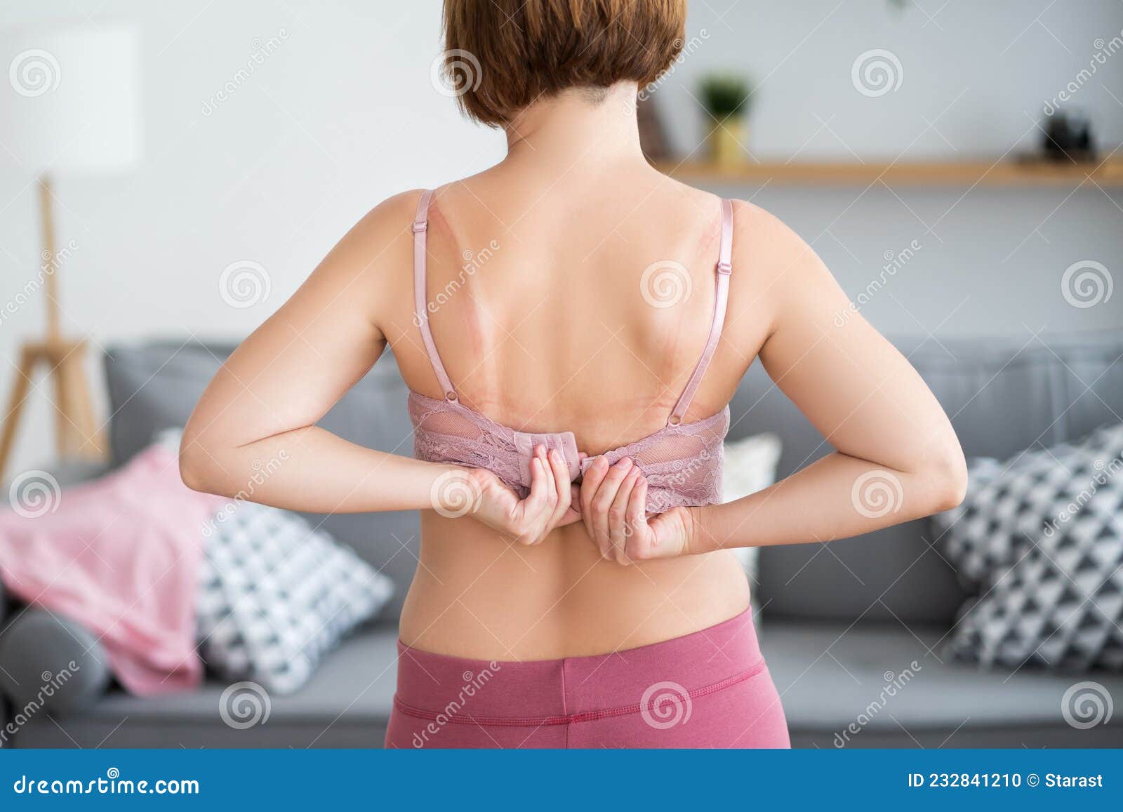 Woman Undressing and Unhooking Her Bra Stock Photo - Image of back