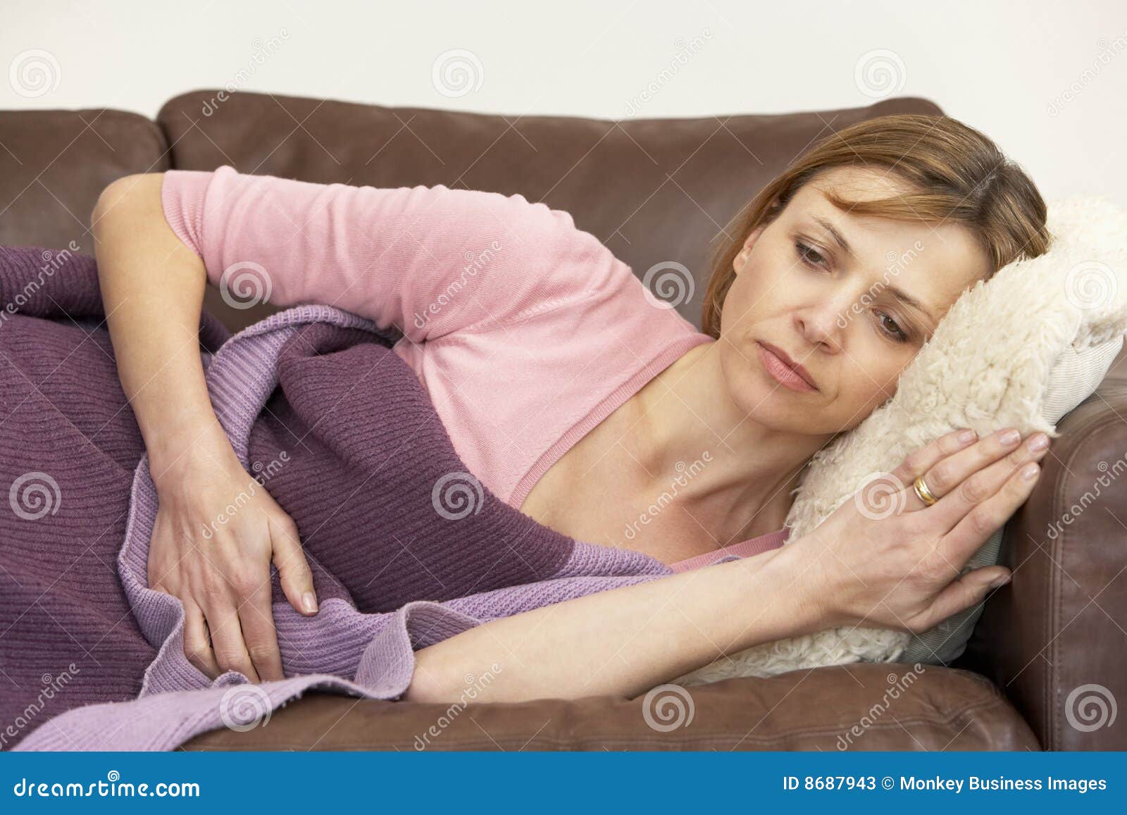 woman unwell and lying on sofa