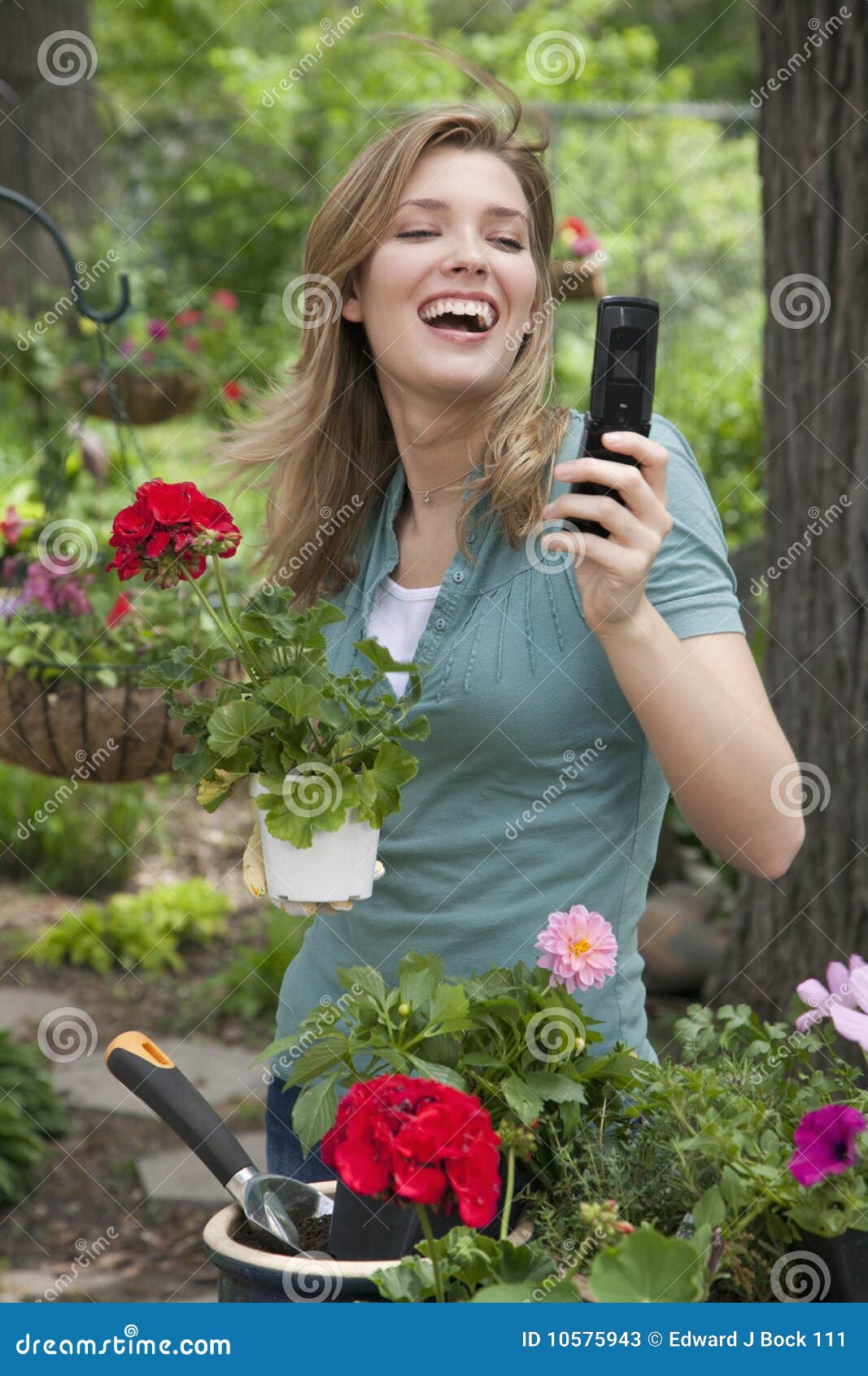 Woman Using Cell Phone while Gardening Stock Image - Image of hair