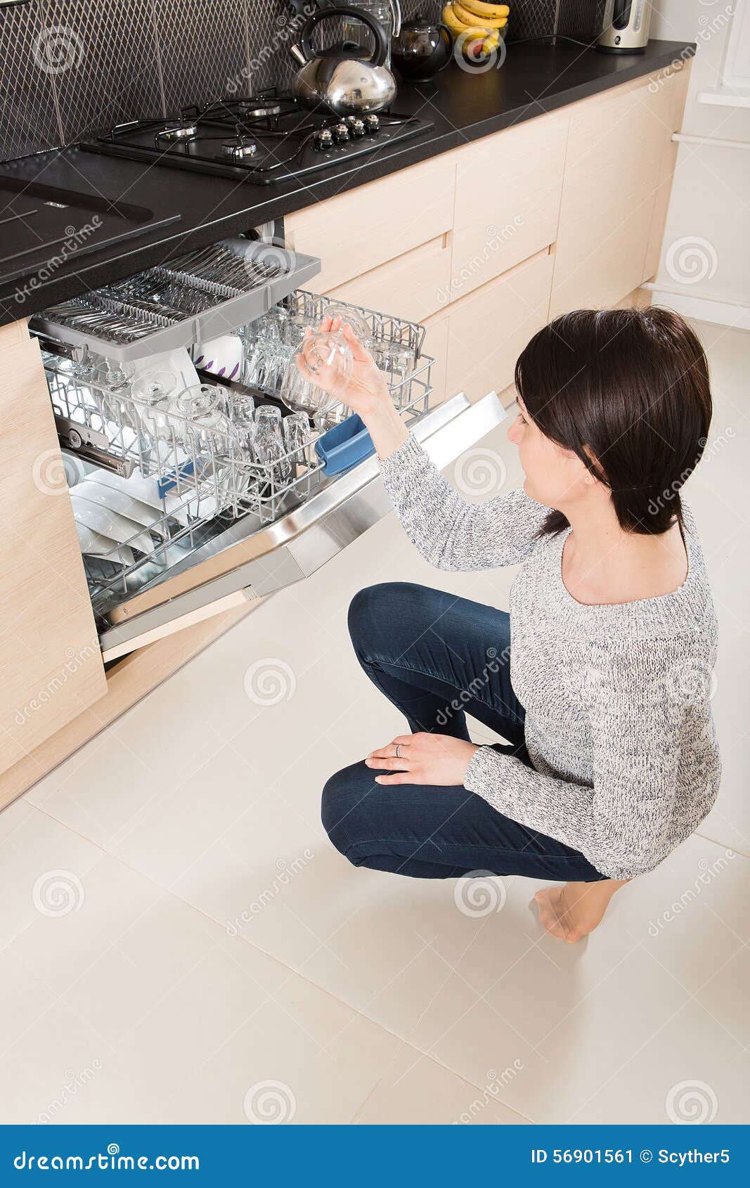Woman Using a Dishwasher in a Modern Kitchen. Stock Image Image of