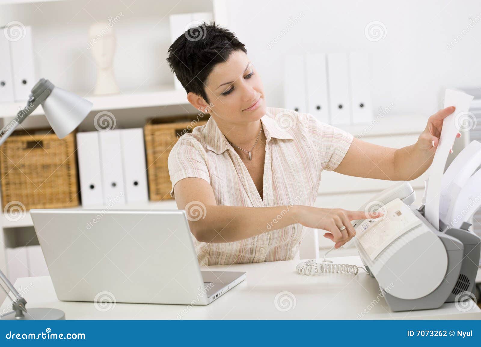 woman using fax machine