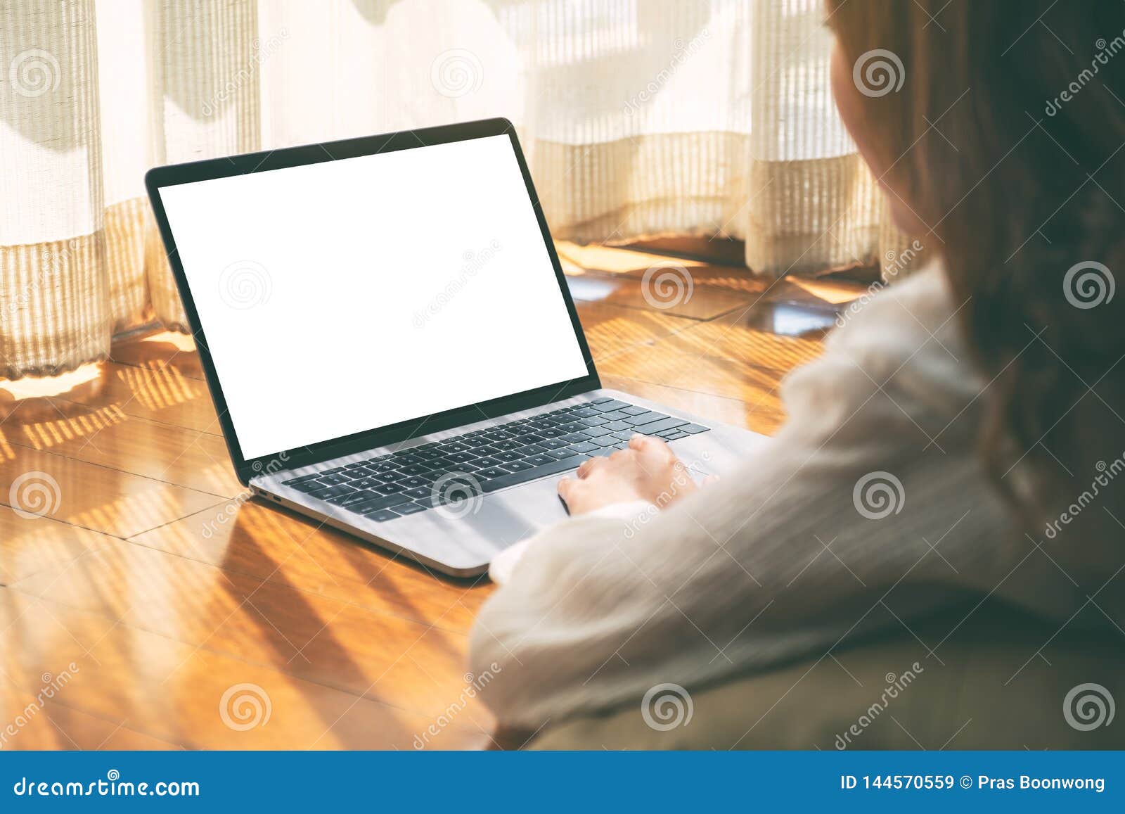 A Woman Using Laptop Computer With Blank White Desktop Screen