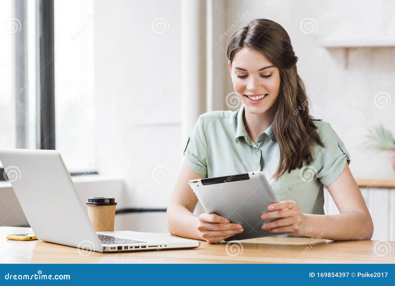 woman using laptop and digital tablet in office. entrepreneur, businesswoman, freelance worker, student working on computer.