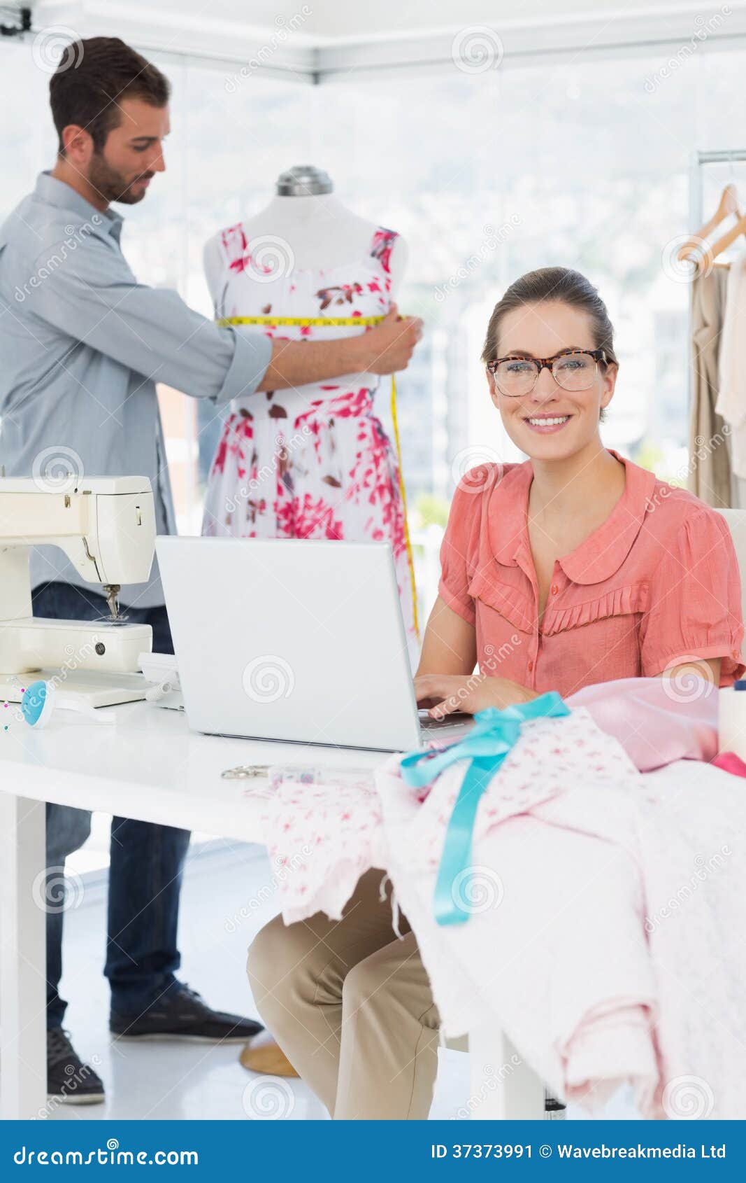 woman using laptop with fashion er working at studio