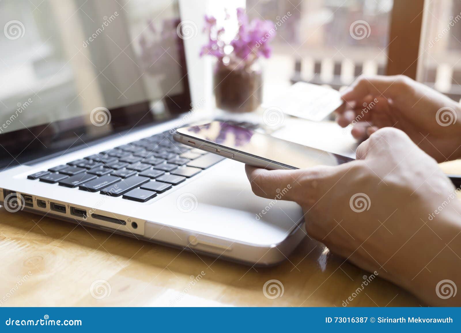 woman using laptop and mobile phone to online shopping and pay by credit card.