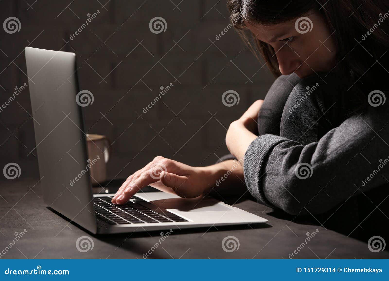 woman using laptop at table against. loneliness concept