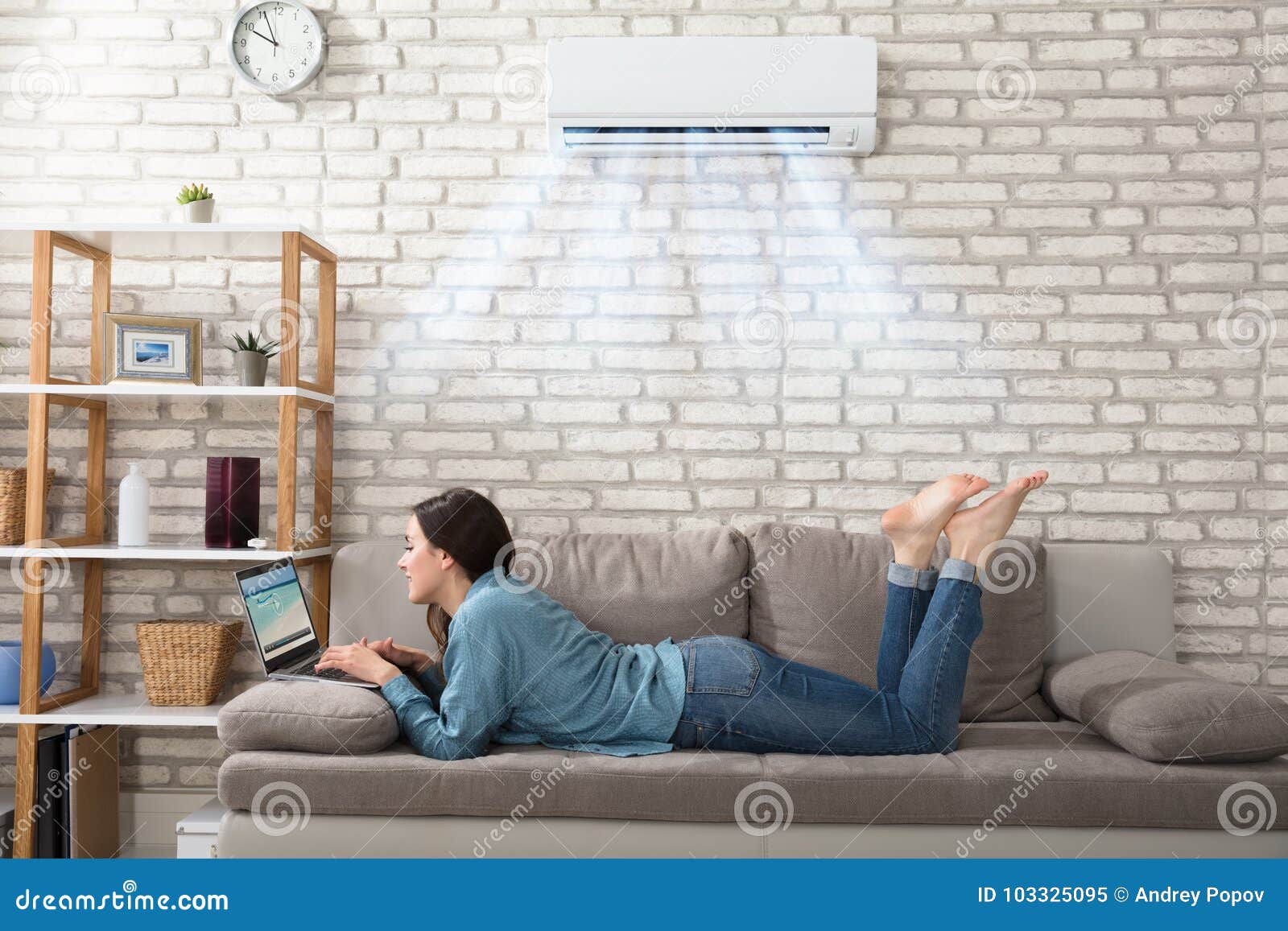 woman using laptop under the air conditioner