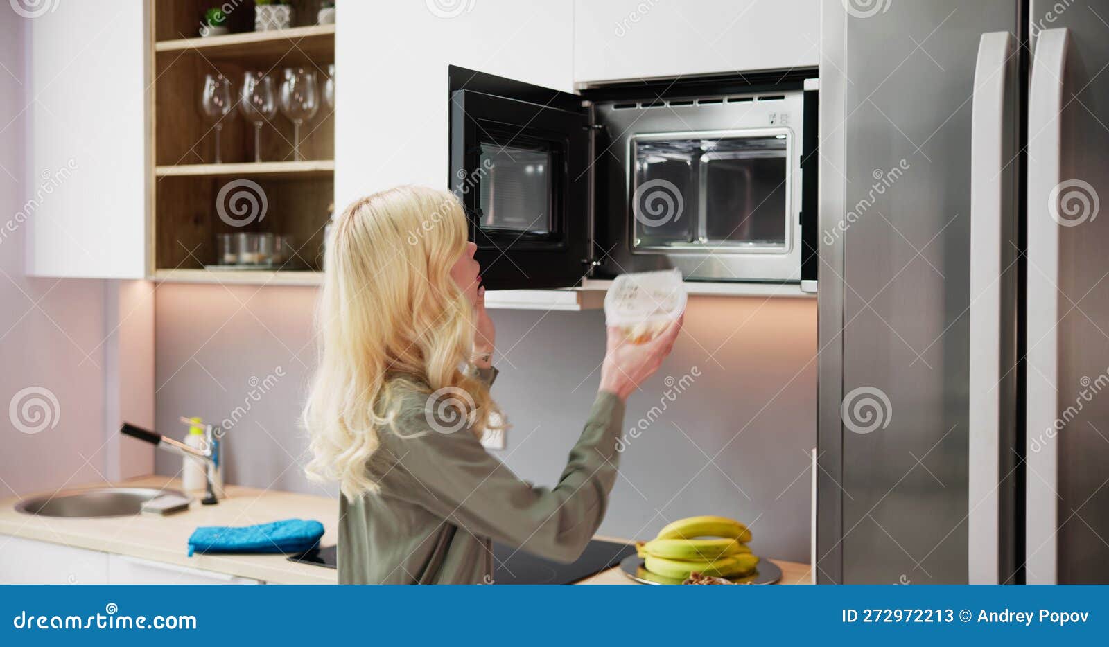 woman using microwave oven for heating food