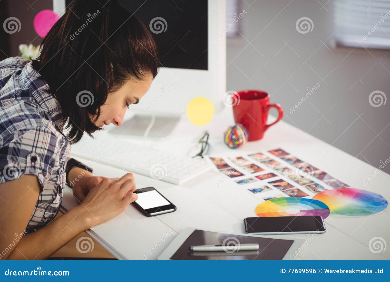 woman using mobile phone in creative ffice