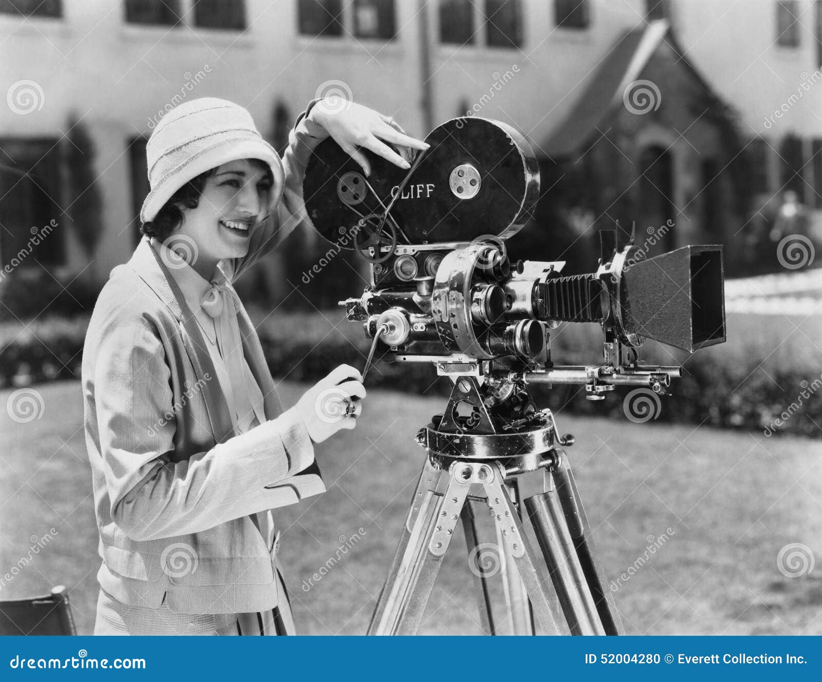 woman using movie camera outdoors