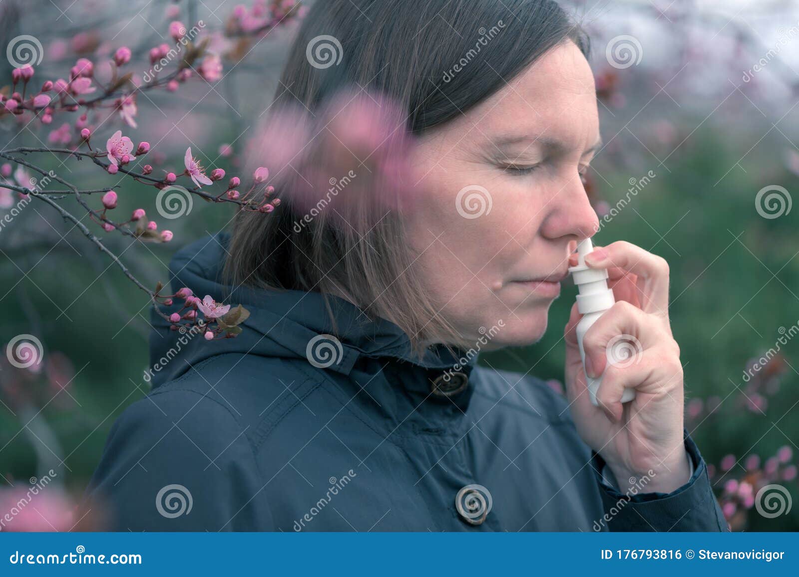woman using nasal spray outdoors