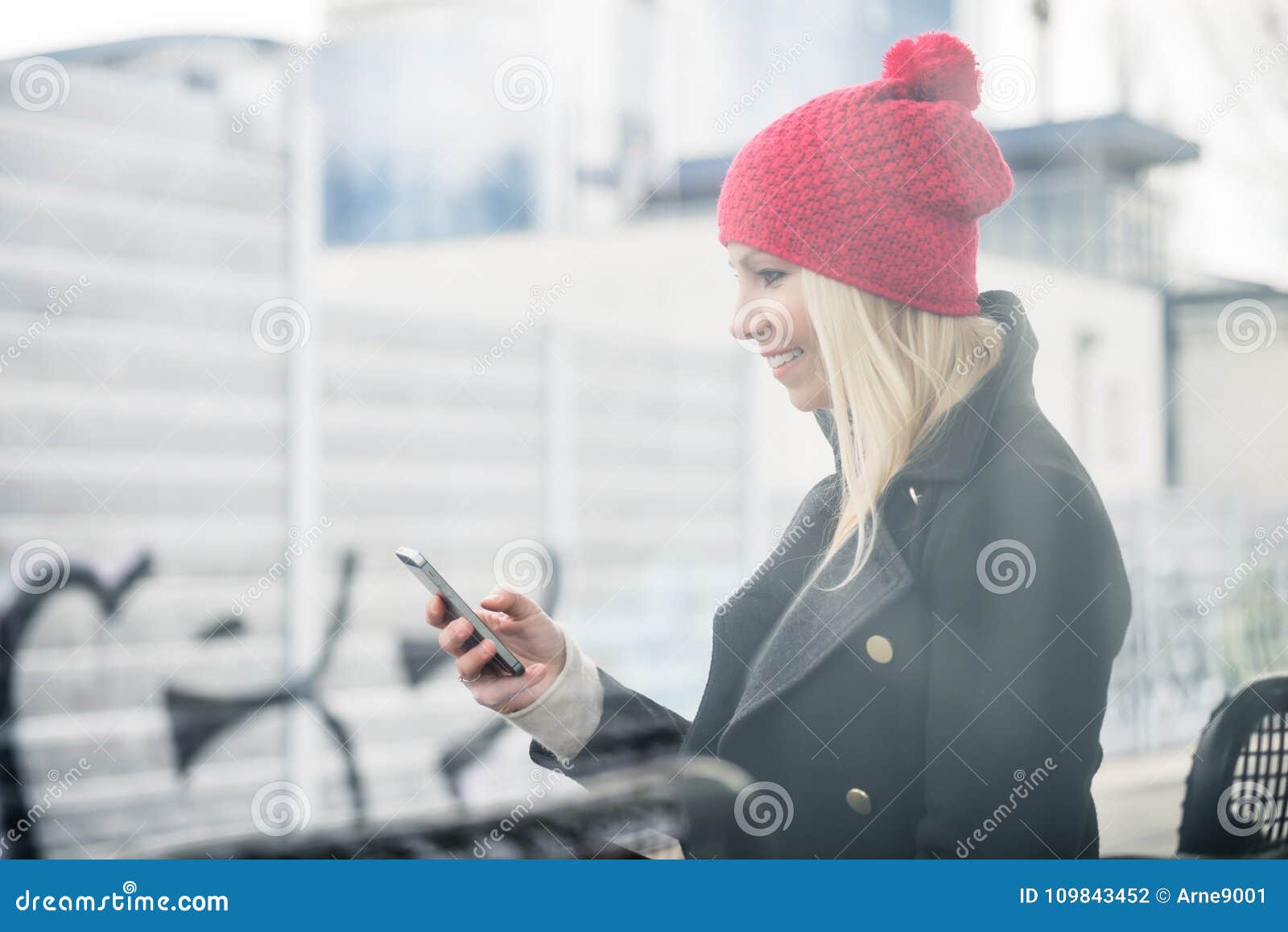 Woman Using Phone while Waiting for a Suburban Train Stock Photo ...
