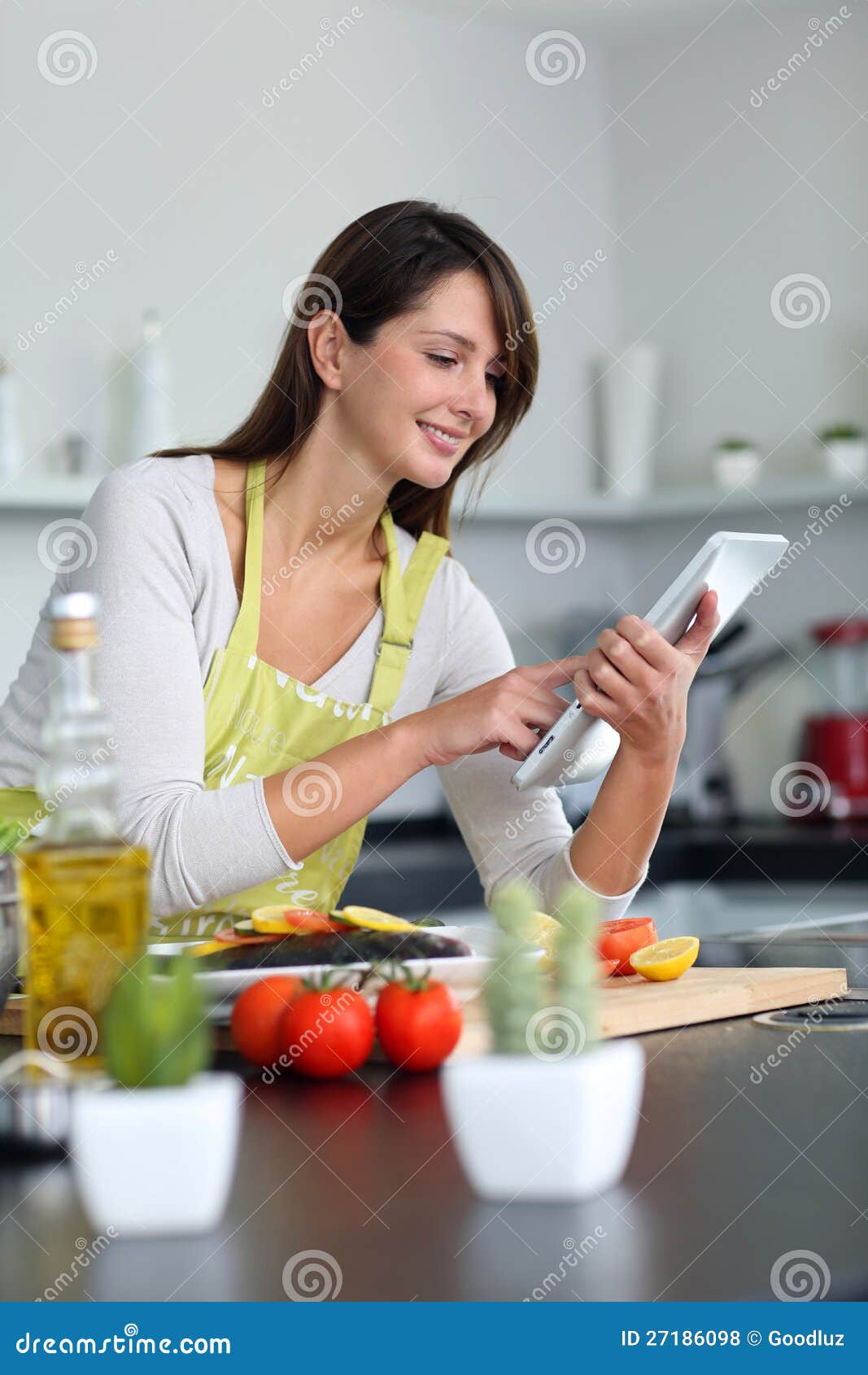 Woman Using Tablet in Kitchen Stock Photo Image of food, cooker 27186098