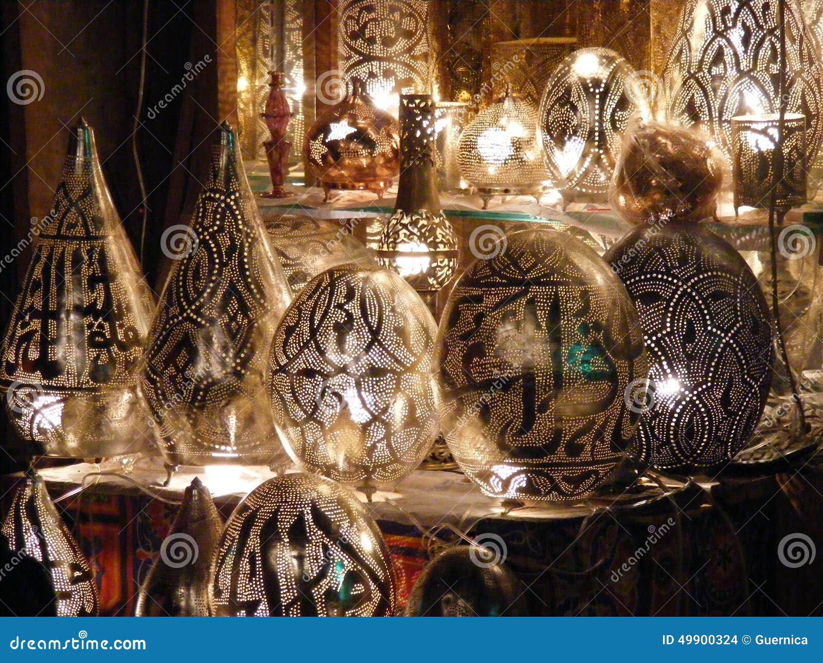 shining lanterns in khan el khalili souq market with arabic handwriting on it in egypt cairo
