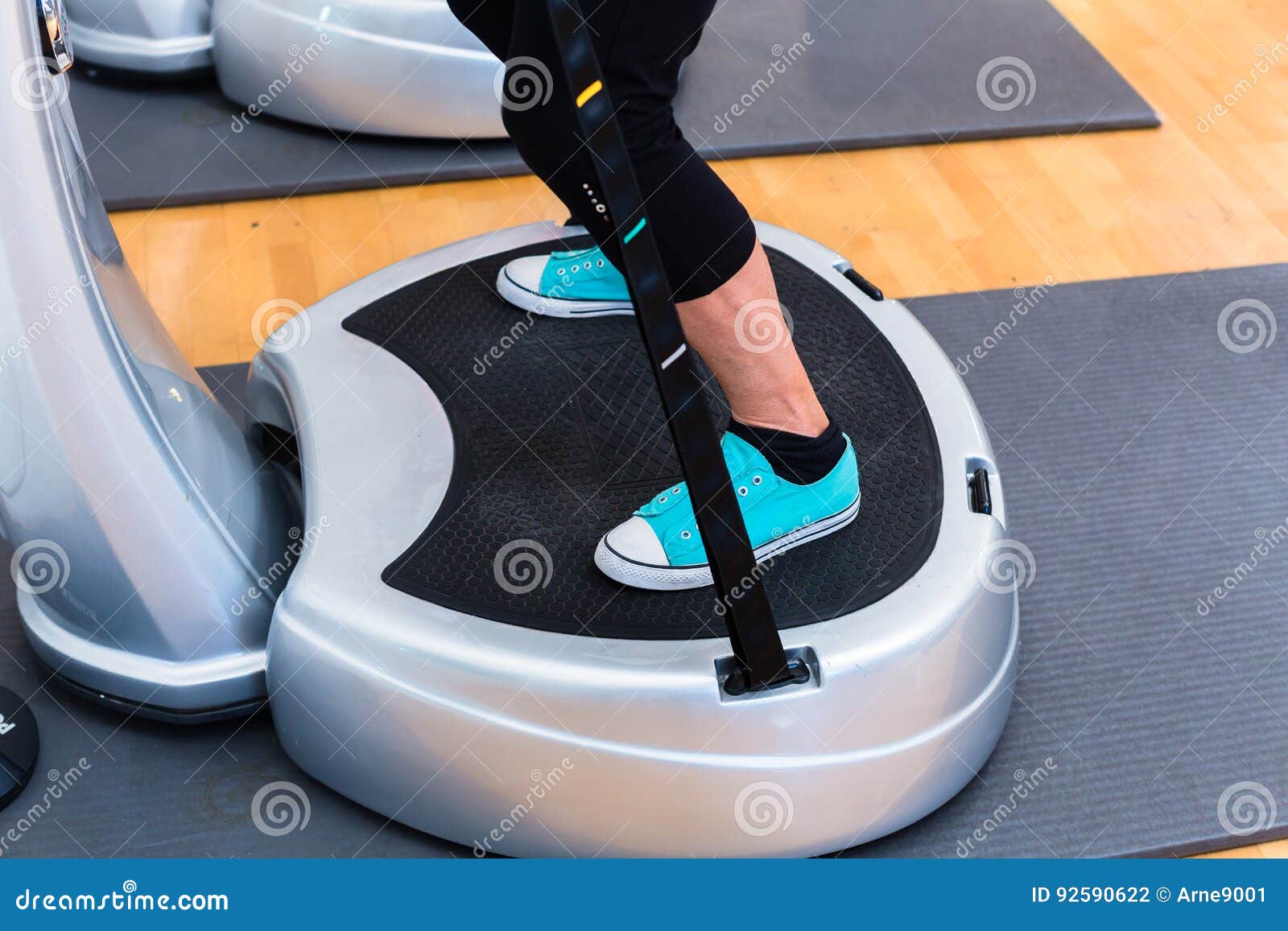 woman on vibrating plates in gym training