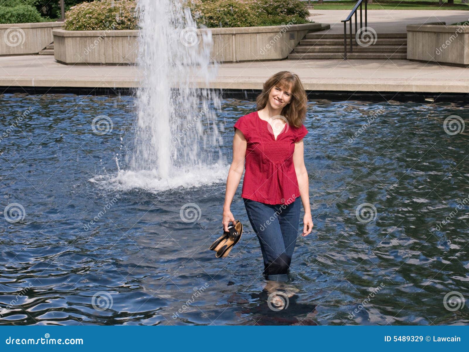 woman wading in pond