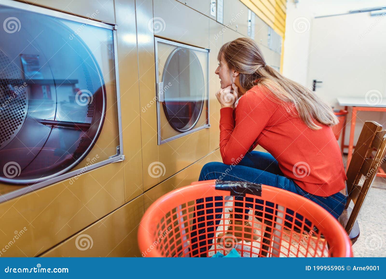 Woman Waits On Chair In Front Of Washing Machine Stock Image Image Of Patience Launderette