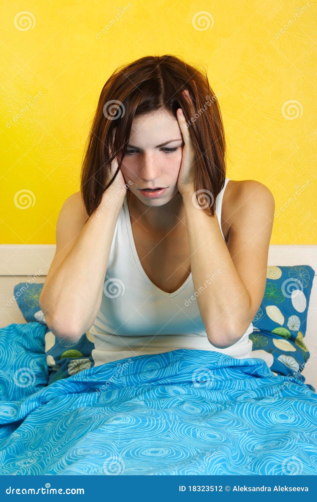 woman waking up after nightmare, hands on head