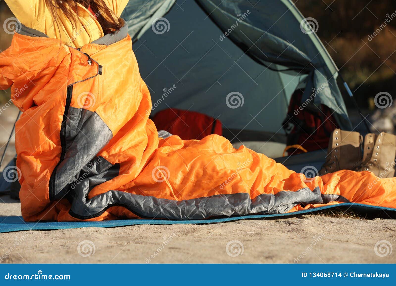 Woman Waking Up in Sleeping Bag Near Tent Stock Photo - Image of ...