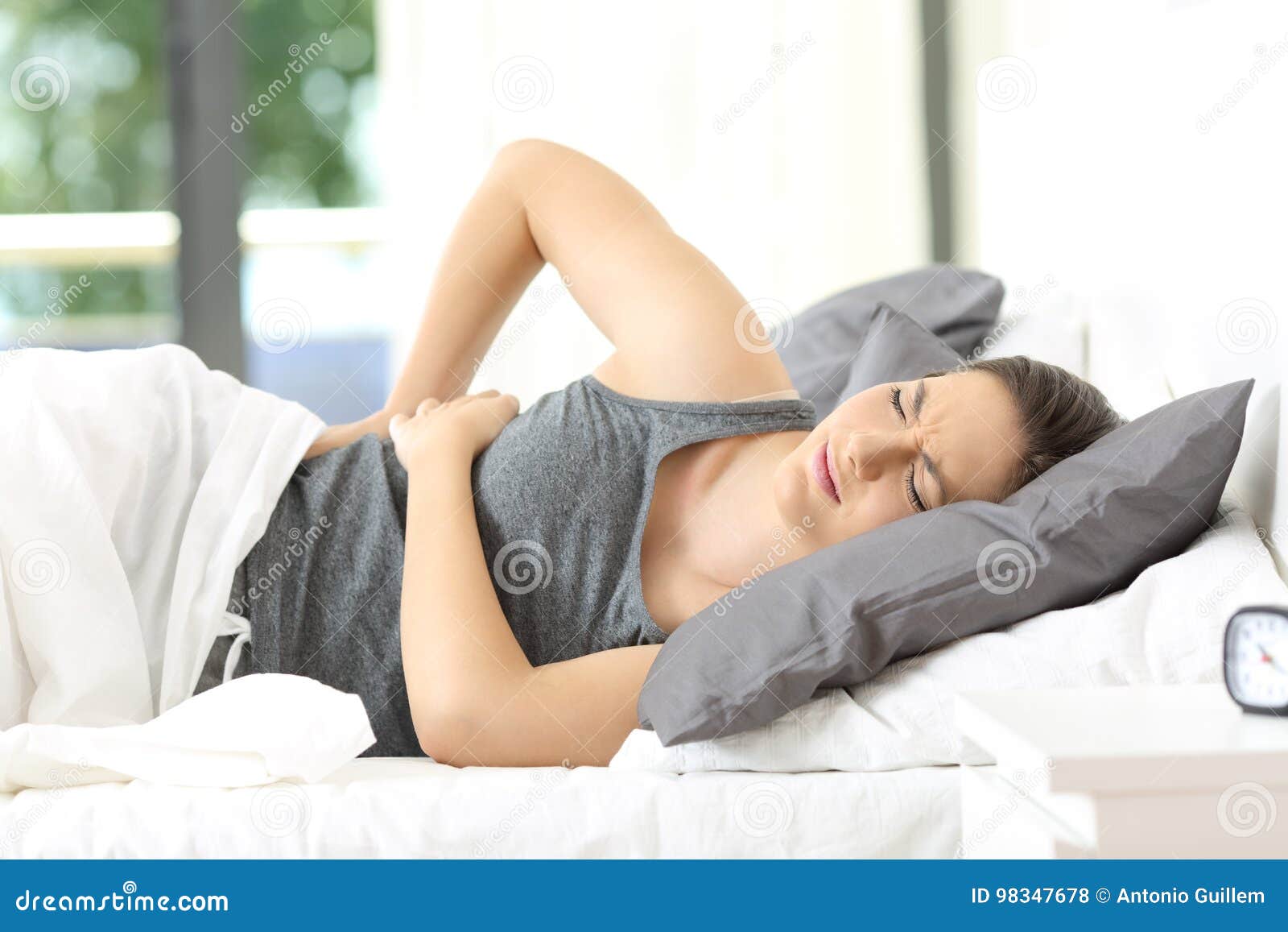 woman waking up suffering back ache