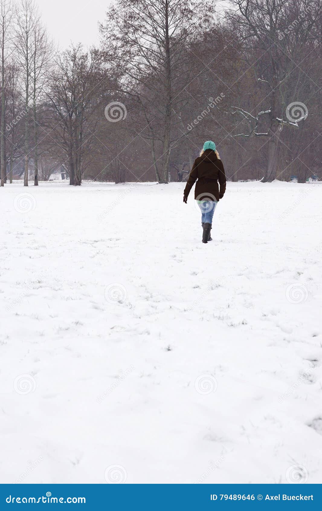 Woman Walking Across Snow Covered Field Stock Photo - Image of snow ...