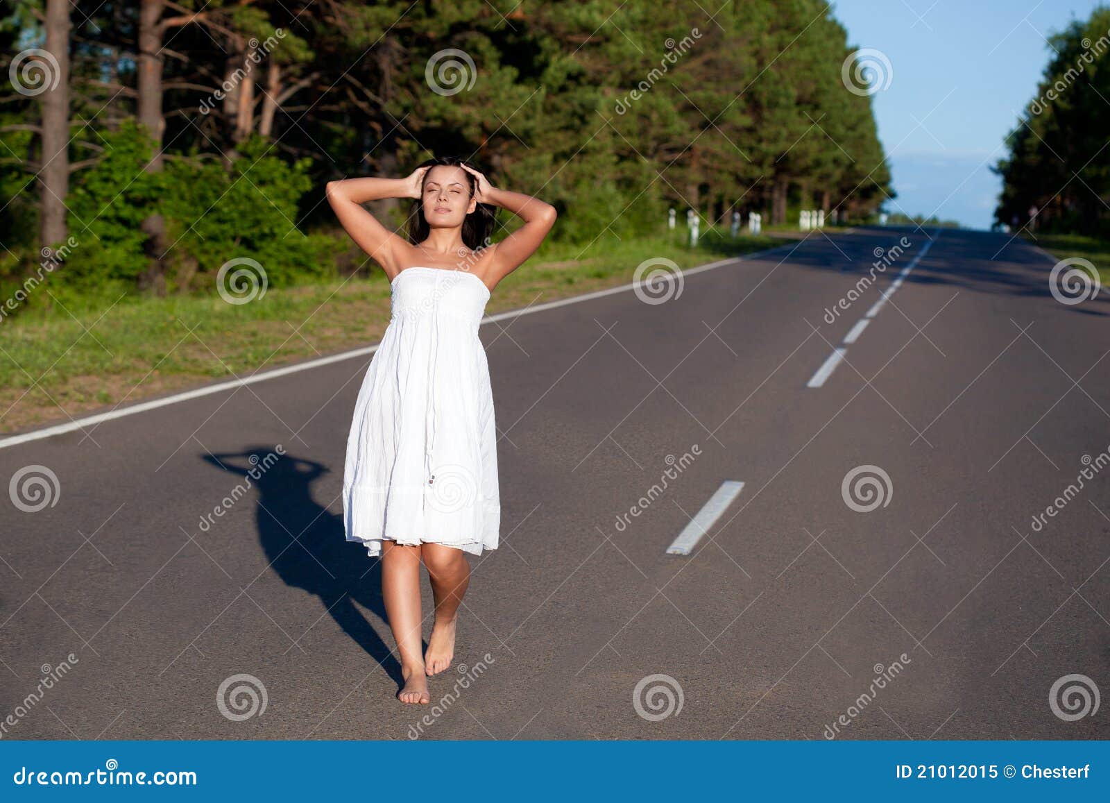 https://thumbs.dreamstime.com/z/woman-walking-along-road-21012015.jpg?ct=jpeg