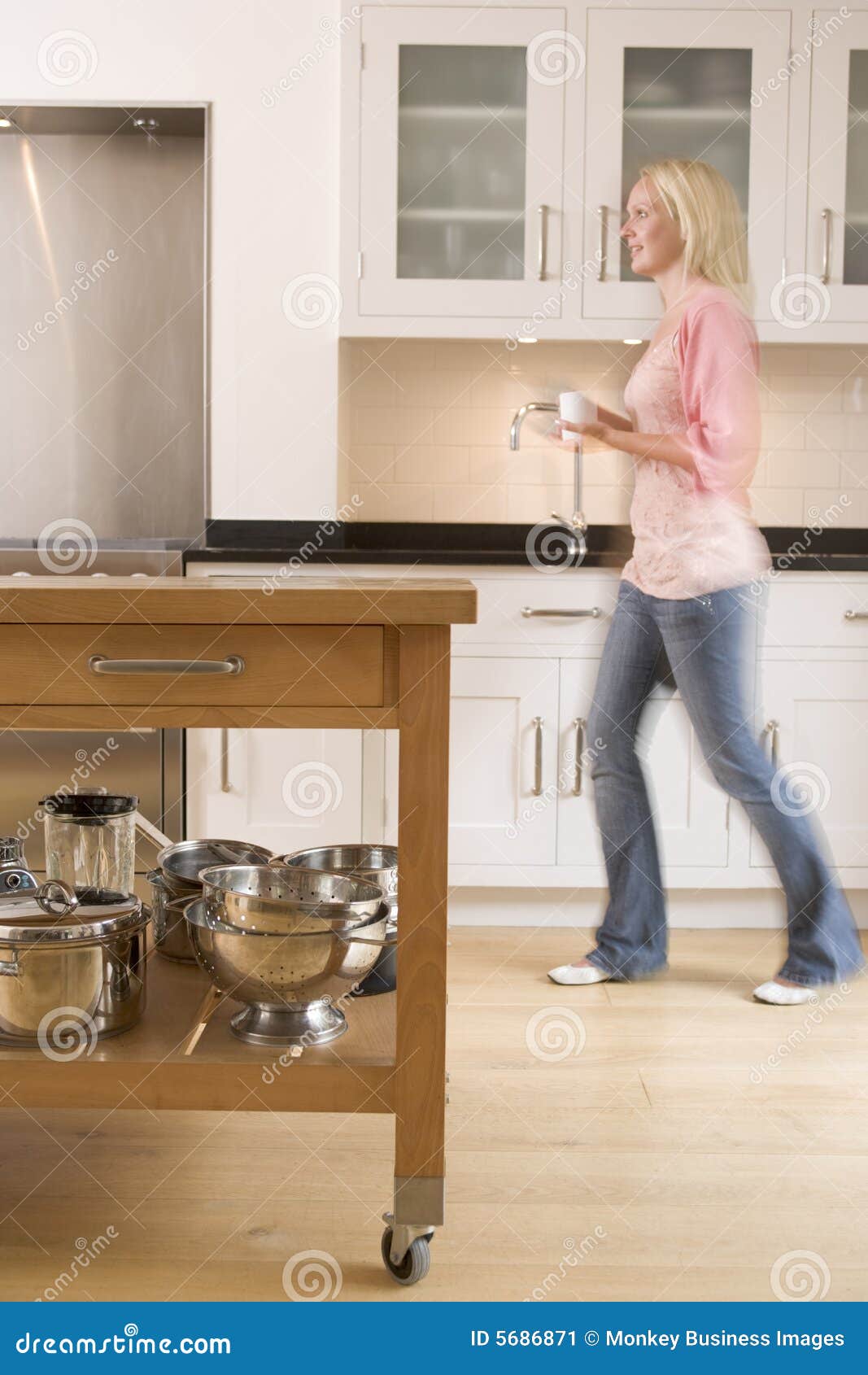 Woman Walking in Kitchen Holding Coffee Stock Image Image of living