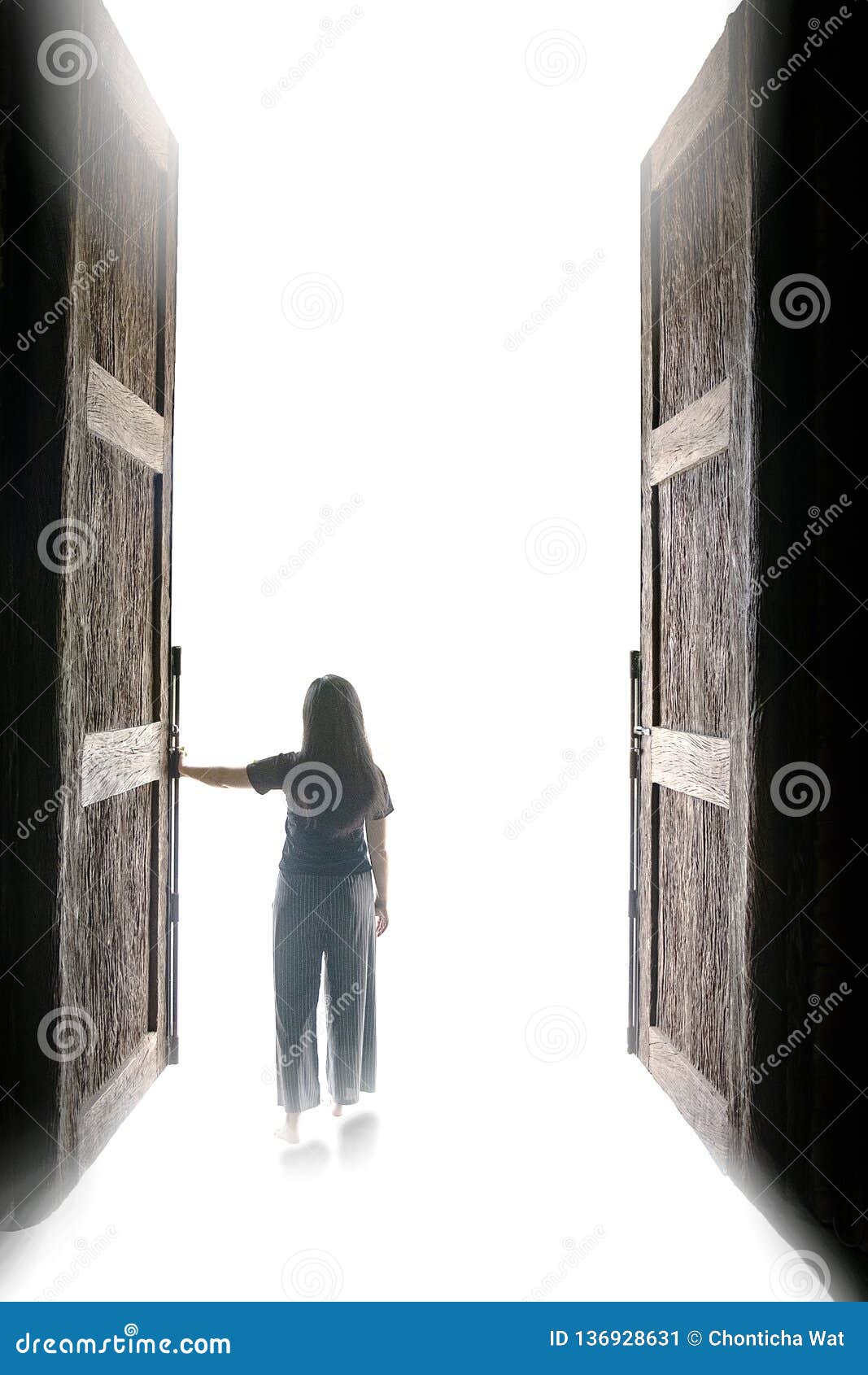 Woman Walking Into The Light Through Open Big Door To Go To