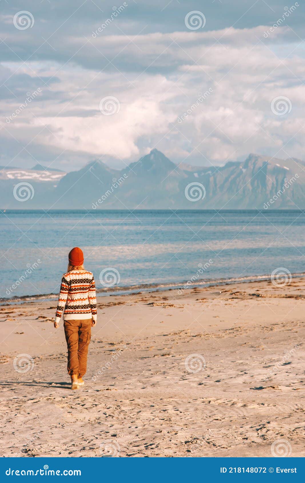 Woman Walking on Sandy Beach Travel Alone in Norway Stock Photo