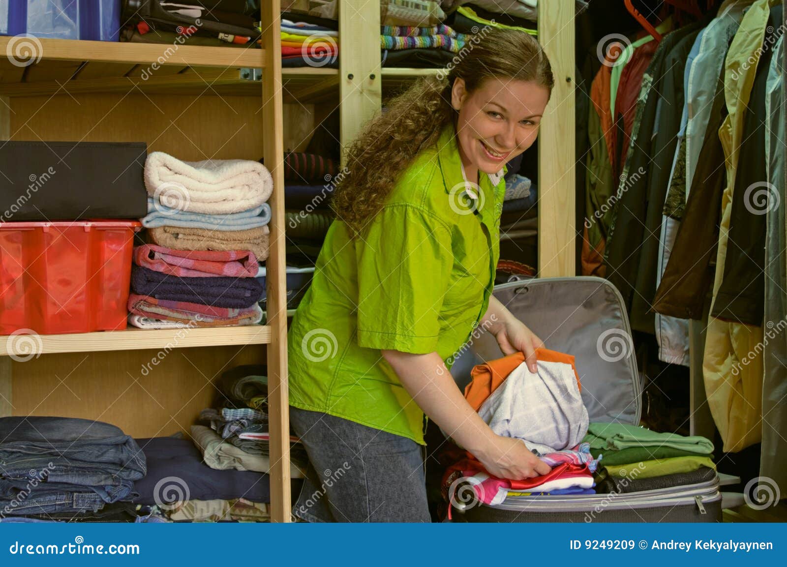 Woman in the Wardrobe Packs Things into a Suitcase Stock Image Image