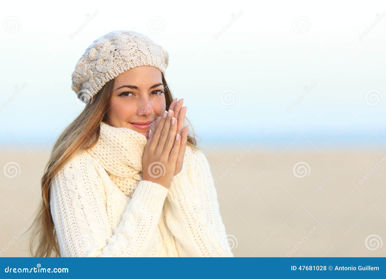 woman warmly clothed in winter on the beach