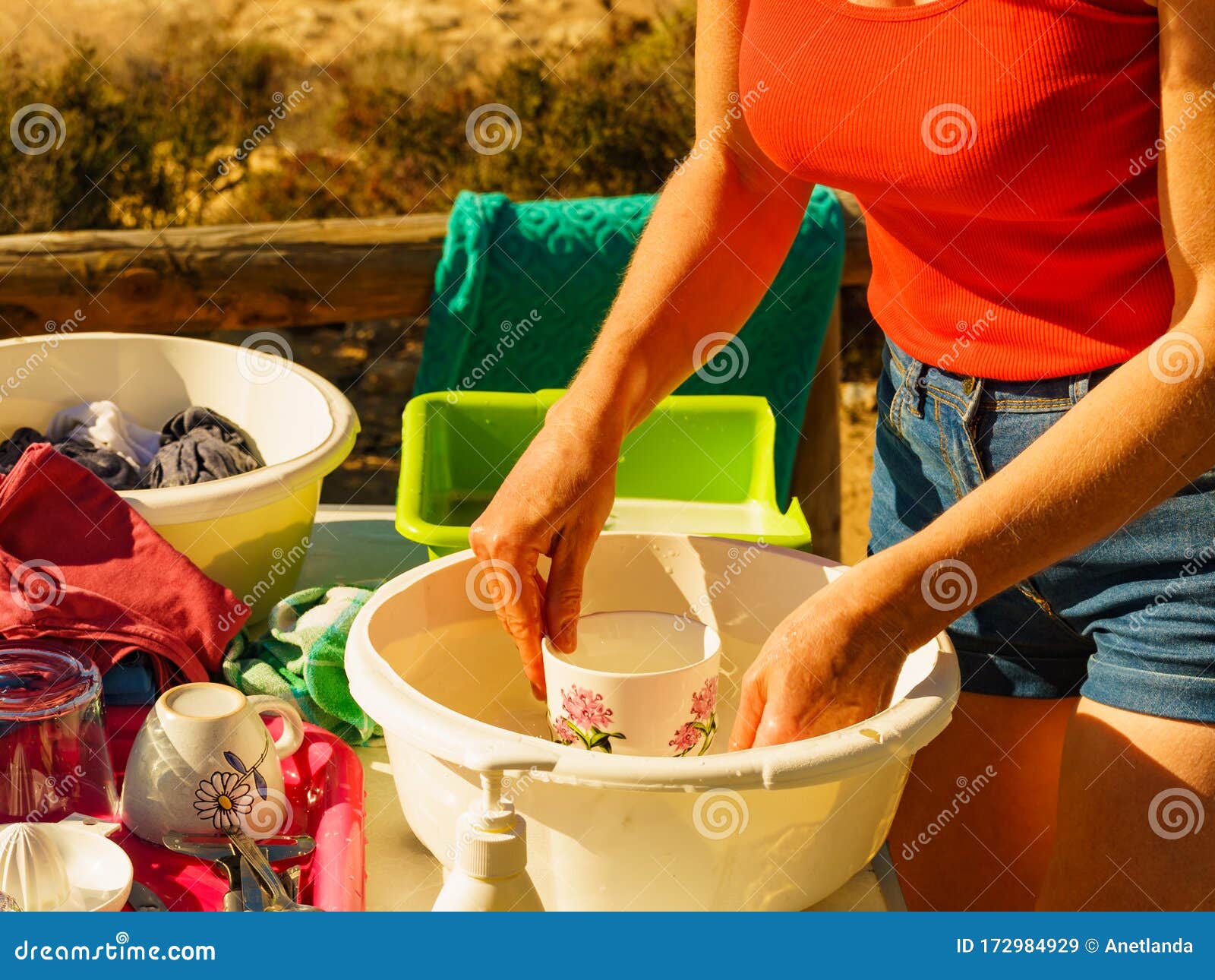 Woman Washing Dishes in Bowl, Capming Outdoor Stock Image - Image of adult,  dirty: 172984929