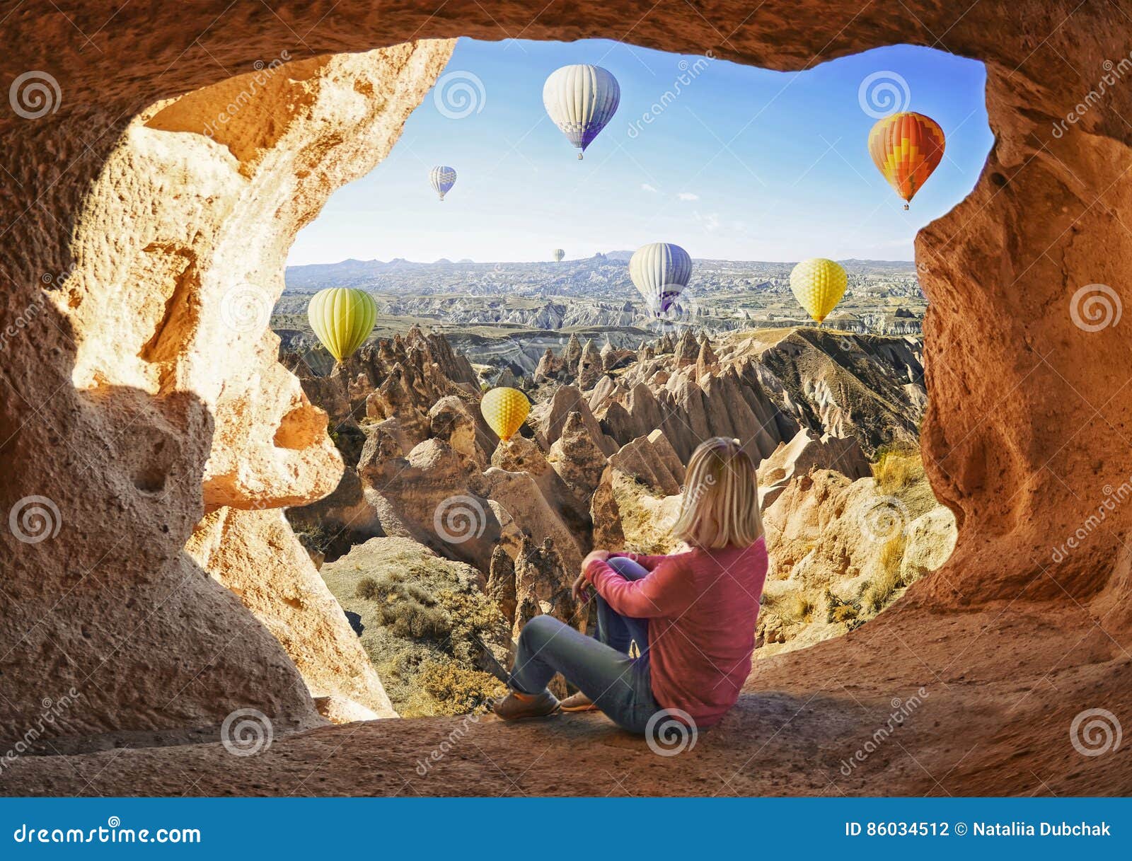 woman watching like colorful hot air balloons flying over the valley at cappadocia