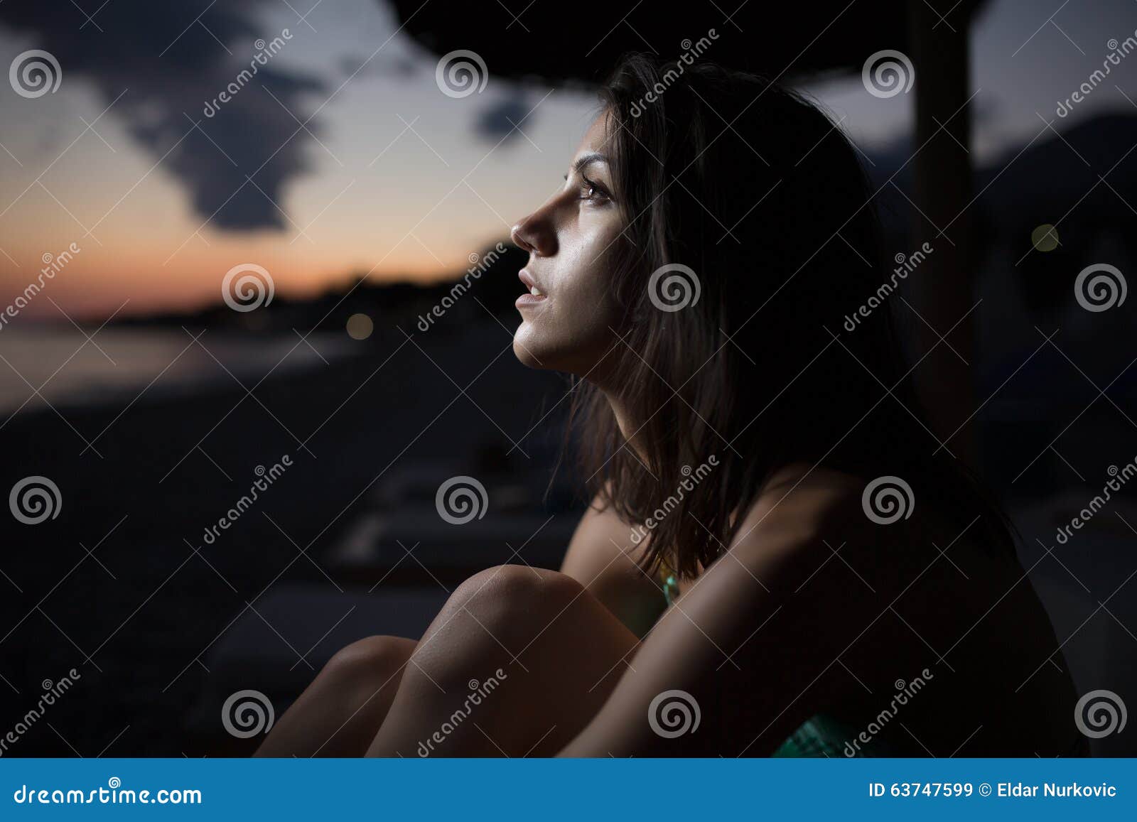 woman watching the ocean,sea horizon with a moon on the sky.eclipse of the moon.eclipse of the sun