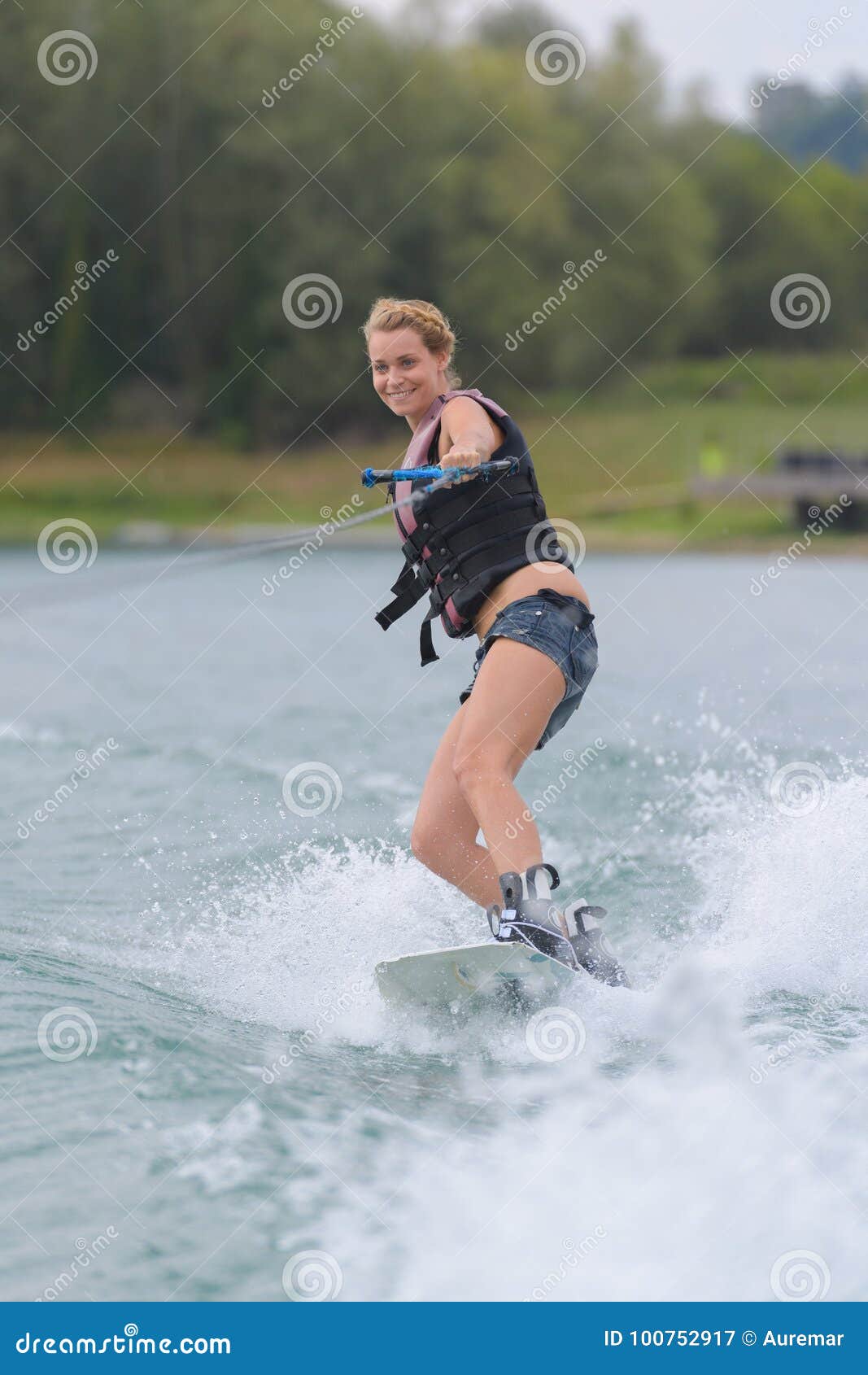 Woman water skiing on lake stock image. Image of back 100752917