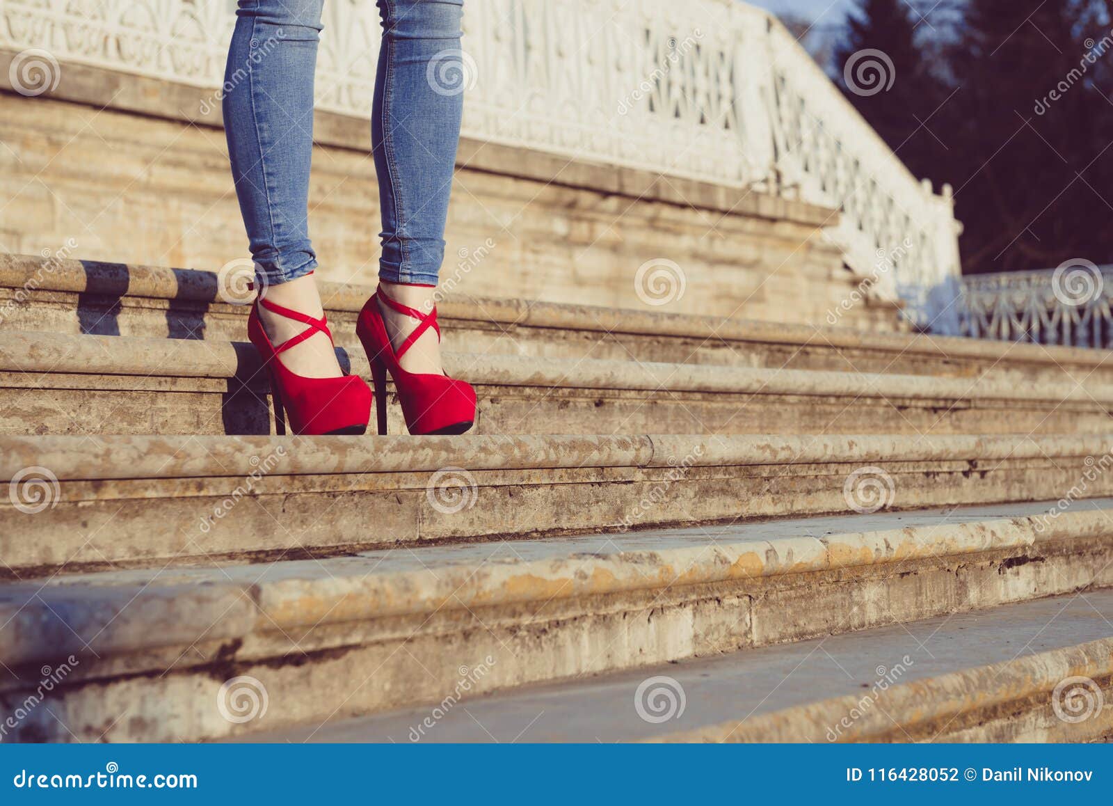 Woman Wearing Blue Jeans and Red High Heel Shoes in Old Town. the Women ...