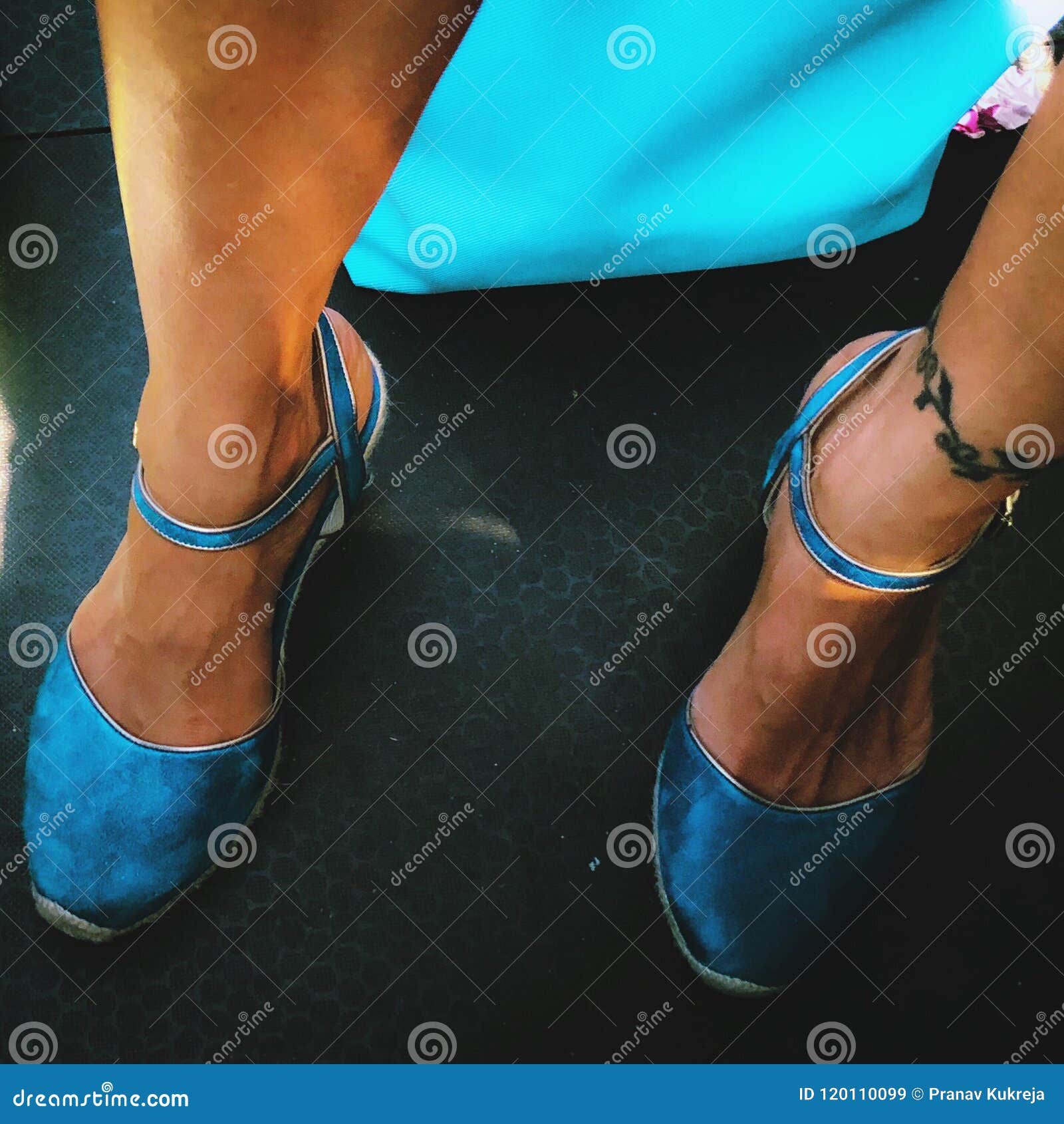 Woman Standing in Blue Shoes Next To Handbag. Stock Image - Image of ...