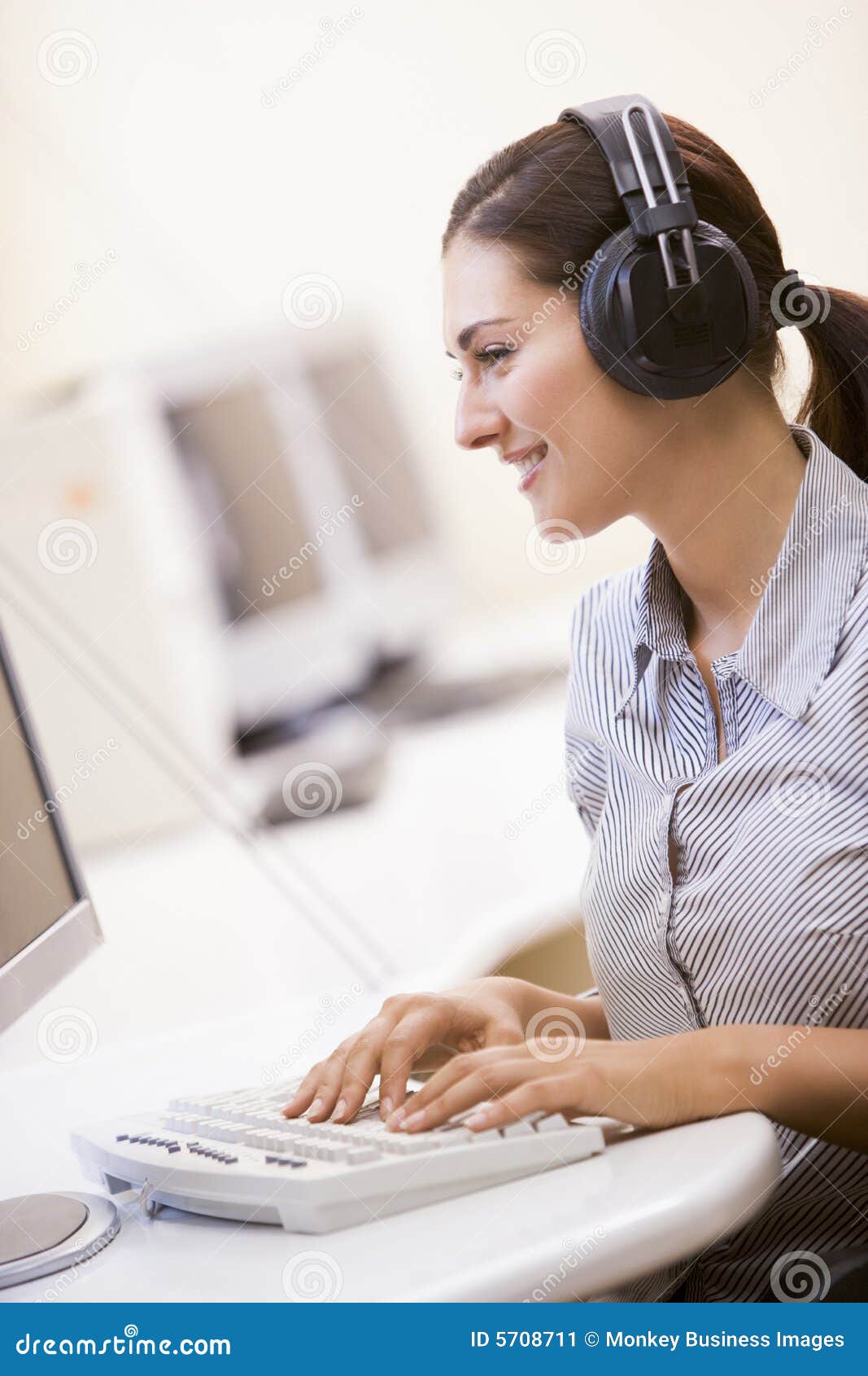 Woman Wearing Headphones in Computer Room Typing Stock Image Image of
