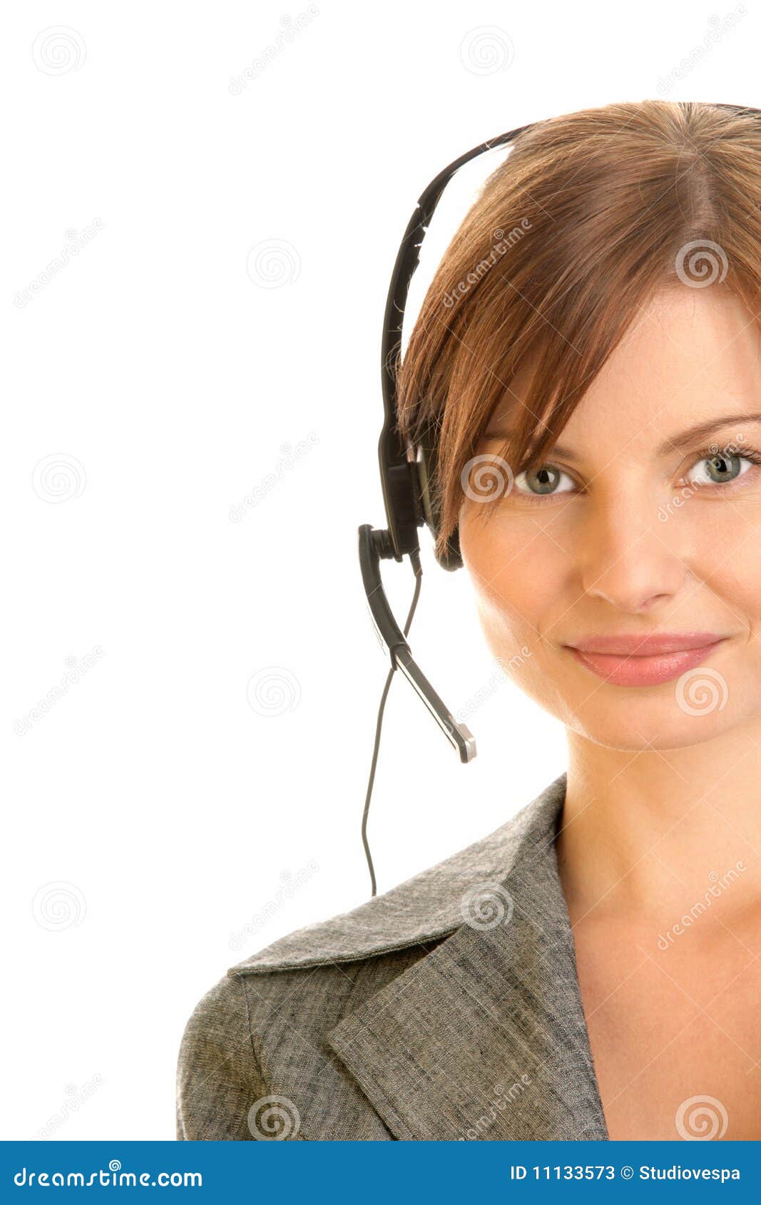 Woman wearing headset. Portrait of friendly secretary/telephone operator wearing headset isolated over white background